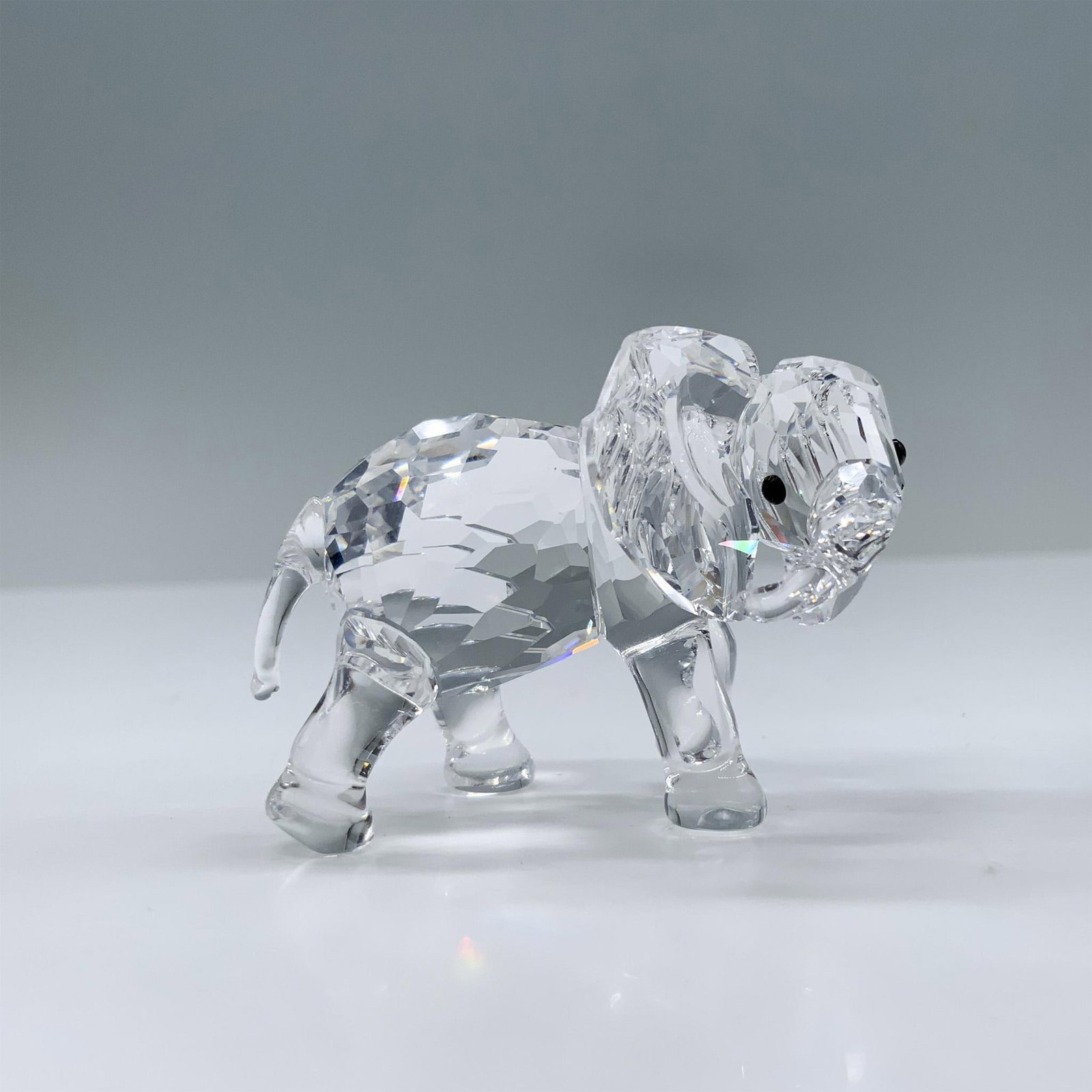 Swarovski Crystal Figurine, Little Elephant: This retired crystal elephant was part of the Rare Encounters group and is made from clear crystal, with black eyes. Item includes original box measuring 4.75"H x 3.25" dia. 674587. Swarovski swan mar
