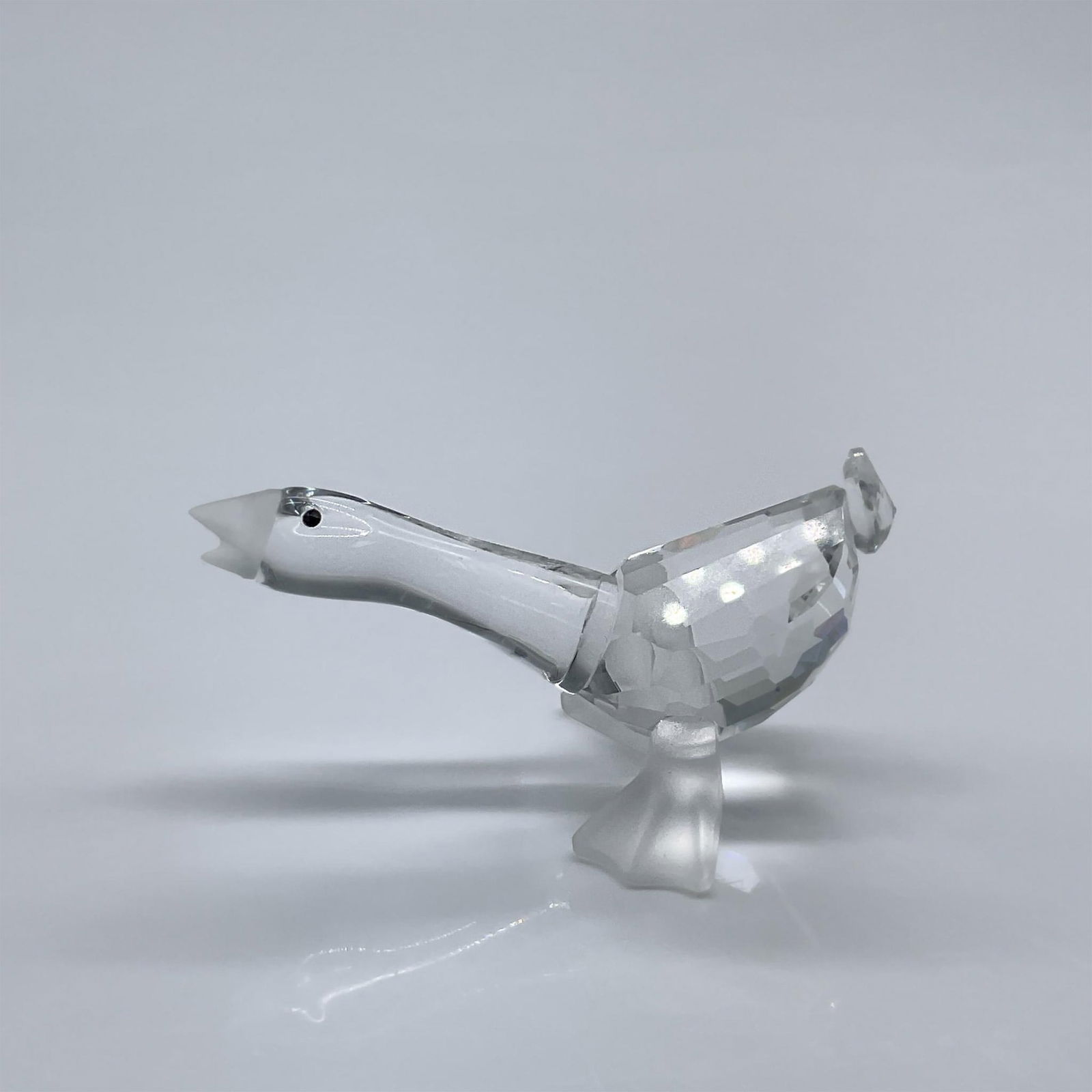 Swarovski Crystal Figurine, Gosling Harry: This figure is made from clear facetted crystal, with black eyes, and a frosted beak and feet. This item has its original box measuring 3.25"L x 3.25"W x 2.5"H. Swarovski acid mark. 174962. Artist: Ad