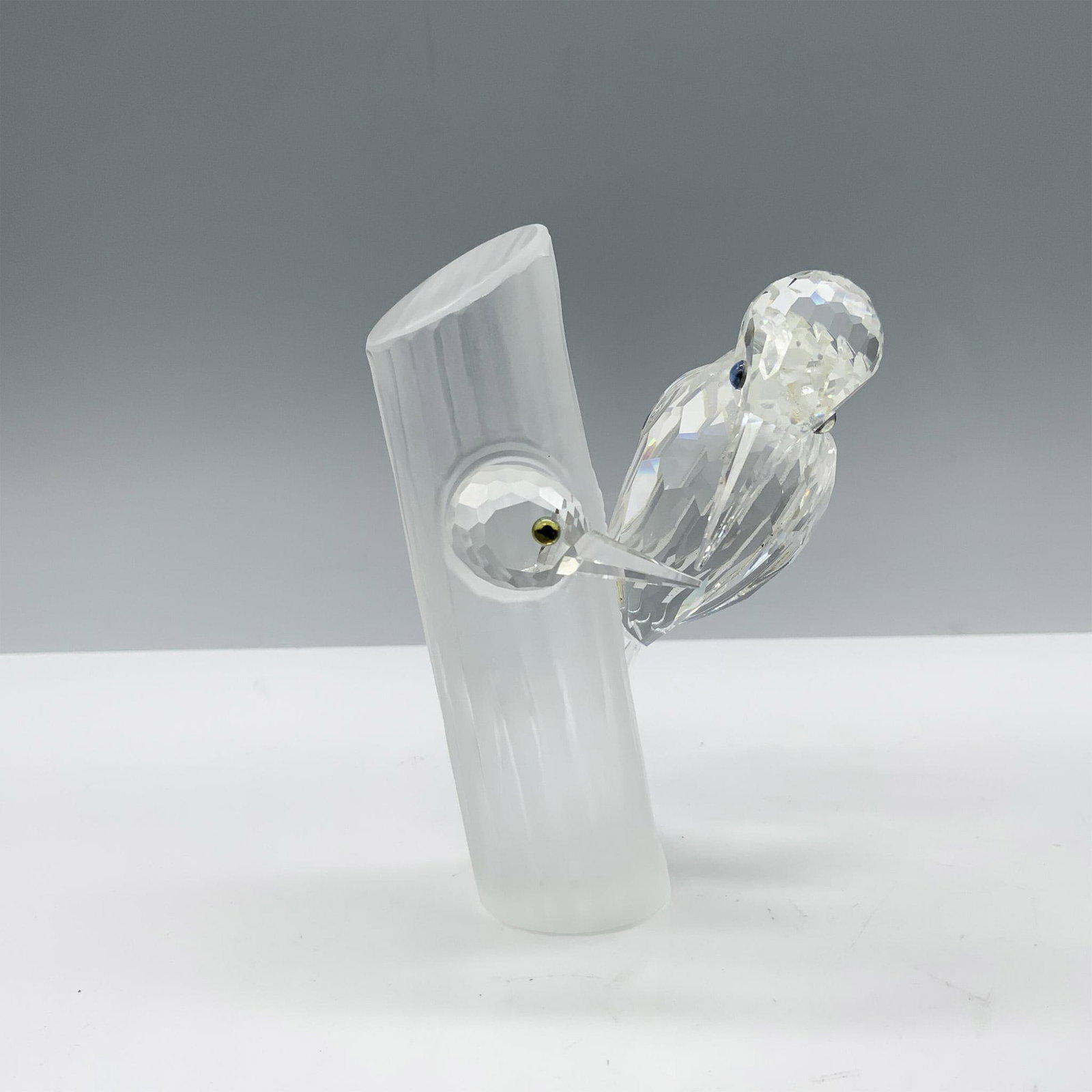 Swarovski Crystal Figurine, Sharing: The Woodpeckers 014745 were the second Annual Edition made for SCS members, and they belong to the Caring and Sharing trilogy. This figurine depicts a parent woodpecker and a baby on a tree trunk. SCS