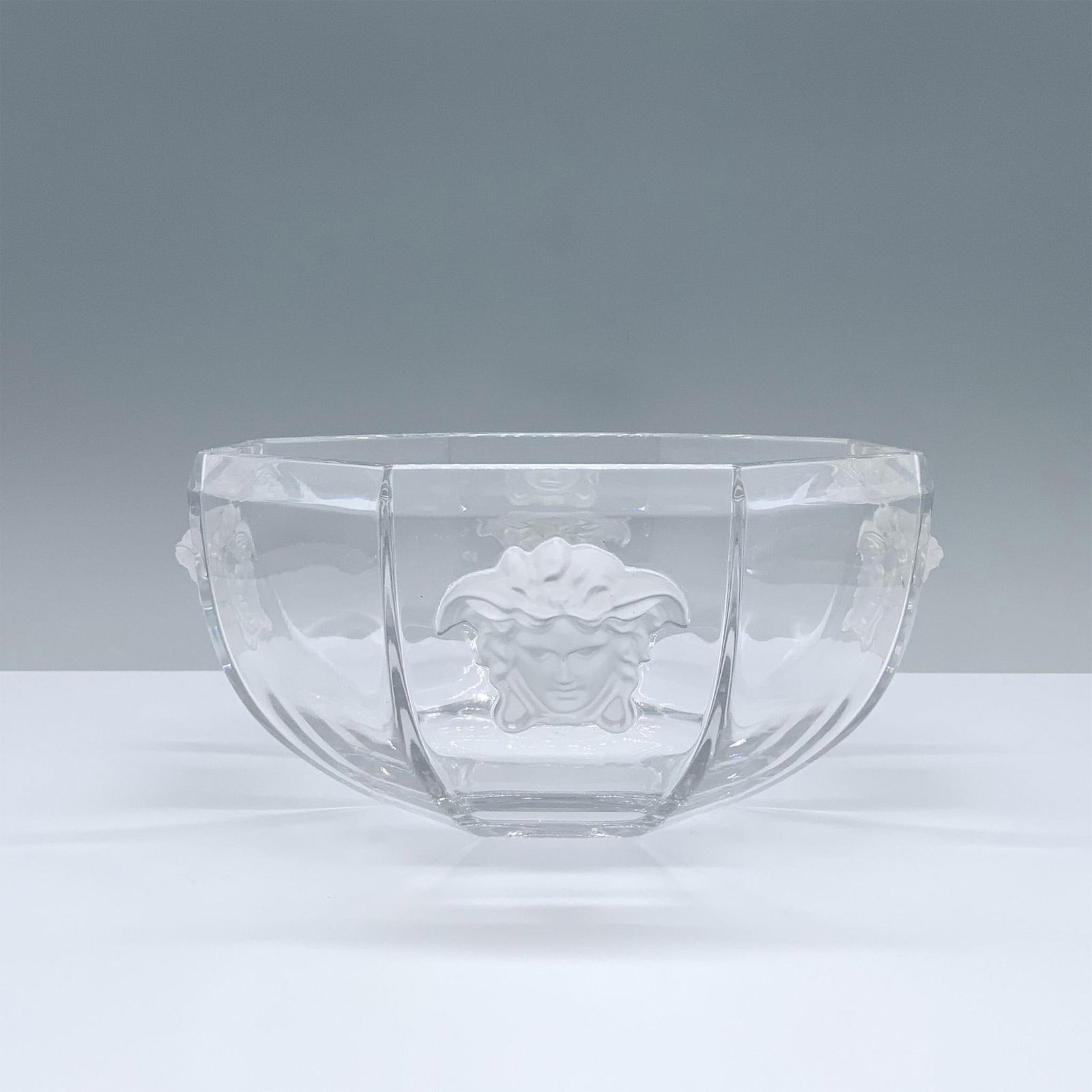 Rosenthal Studio-Linie Versace Glass Bowl: Clear faceted octagonal glass bowl featuring intricate detailed Medusa on each panel. Rosenthal Studio-Linie Versace backstamp. Marked Germany. Dimensions: 8"L x 8"W x 3.5"H Manufacturer: Rosenthal Co