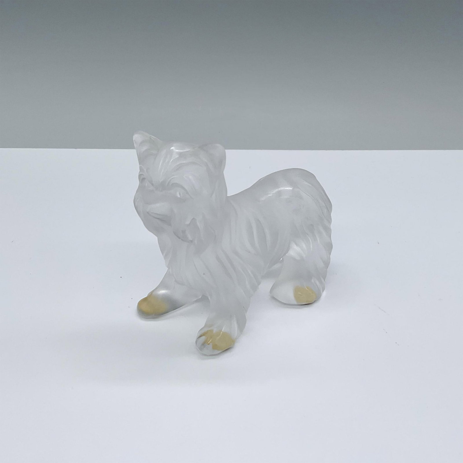 Lalique Crystal Figurine, Yorkshire Terrier: Frosted glass, standing on four legs. Etch marked Lalique, France. Dimensions: 3.75"L x 2"W x 3.5"H Manufacturer: Lalique Country of Origin: France