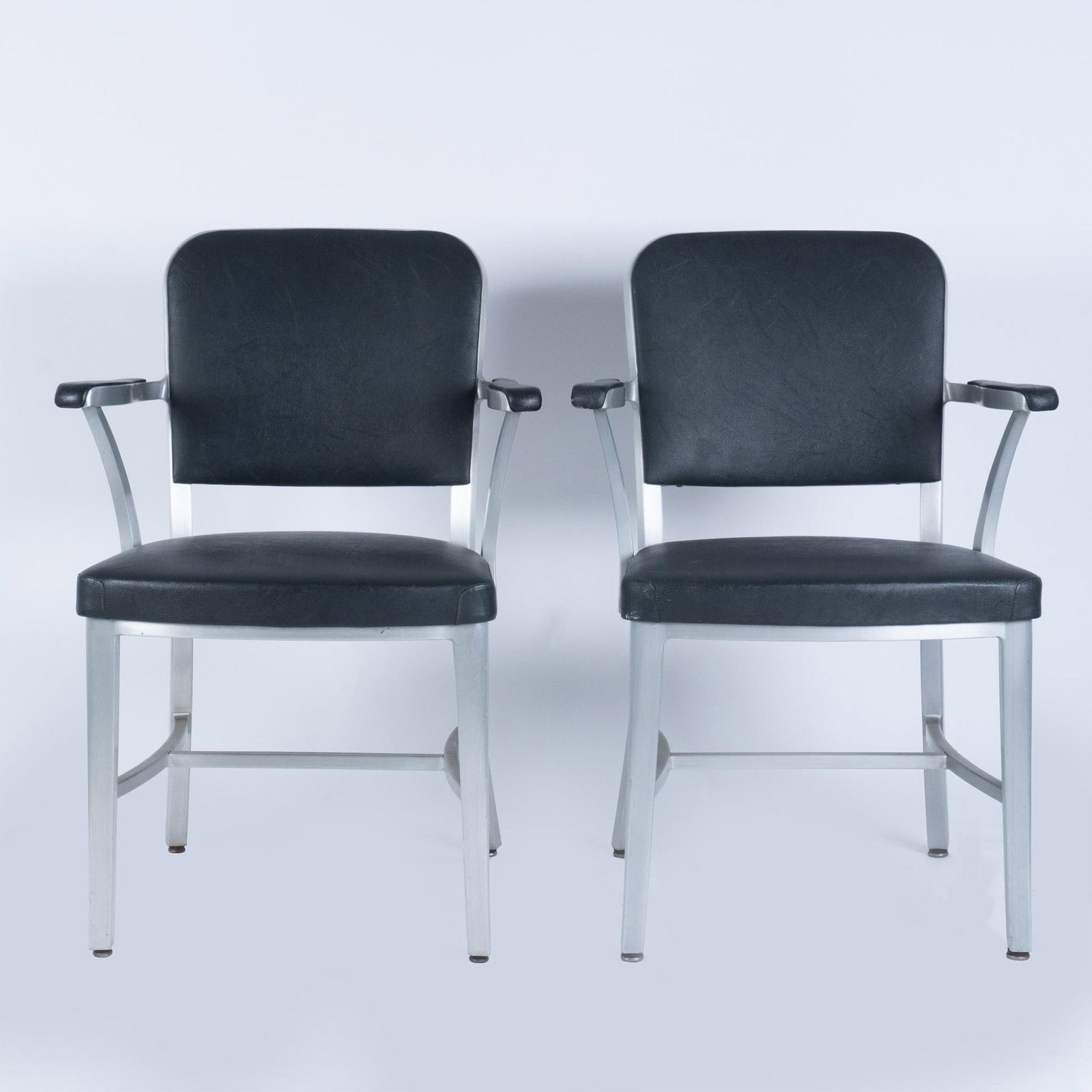 Pair of Vintage Goodform Aluminum Office Chairs: Set of 2 vintage aluminum armed desk chairs with black vinyl upholstery on front, back, arms and seat. Both chairs include original certificates of manufacture under the seats. Issued: 20th century Di
