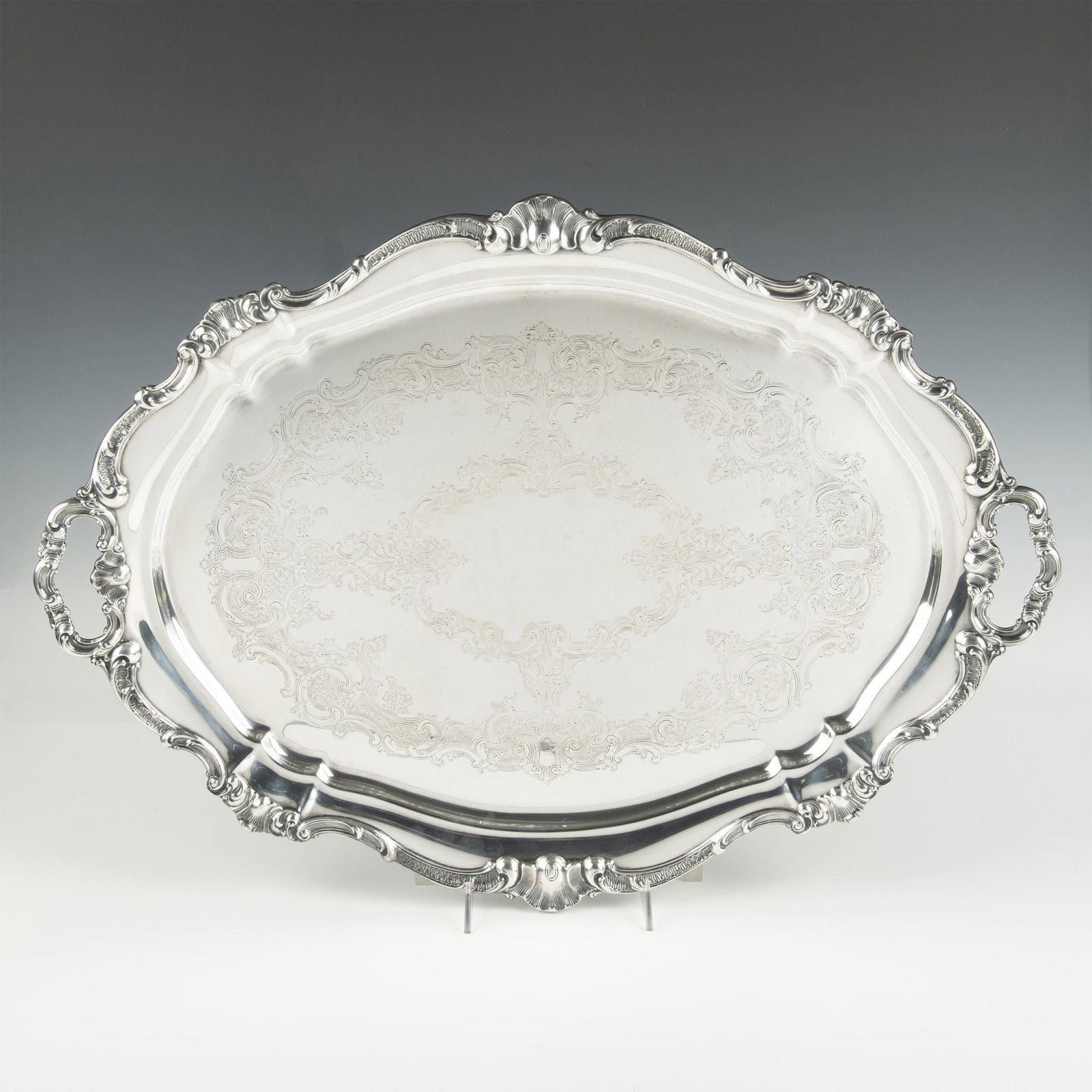 Gorham Electroplate Serving Tray: Has intricate design around the top end and also on serving portion, shape is oval. Issued: 21st century Dimensions: 19.25"L x 26.25"W x 1.5"H Manufacturer: Gorham Country of Origin: United States