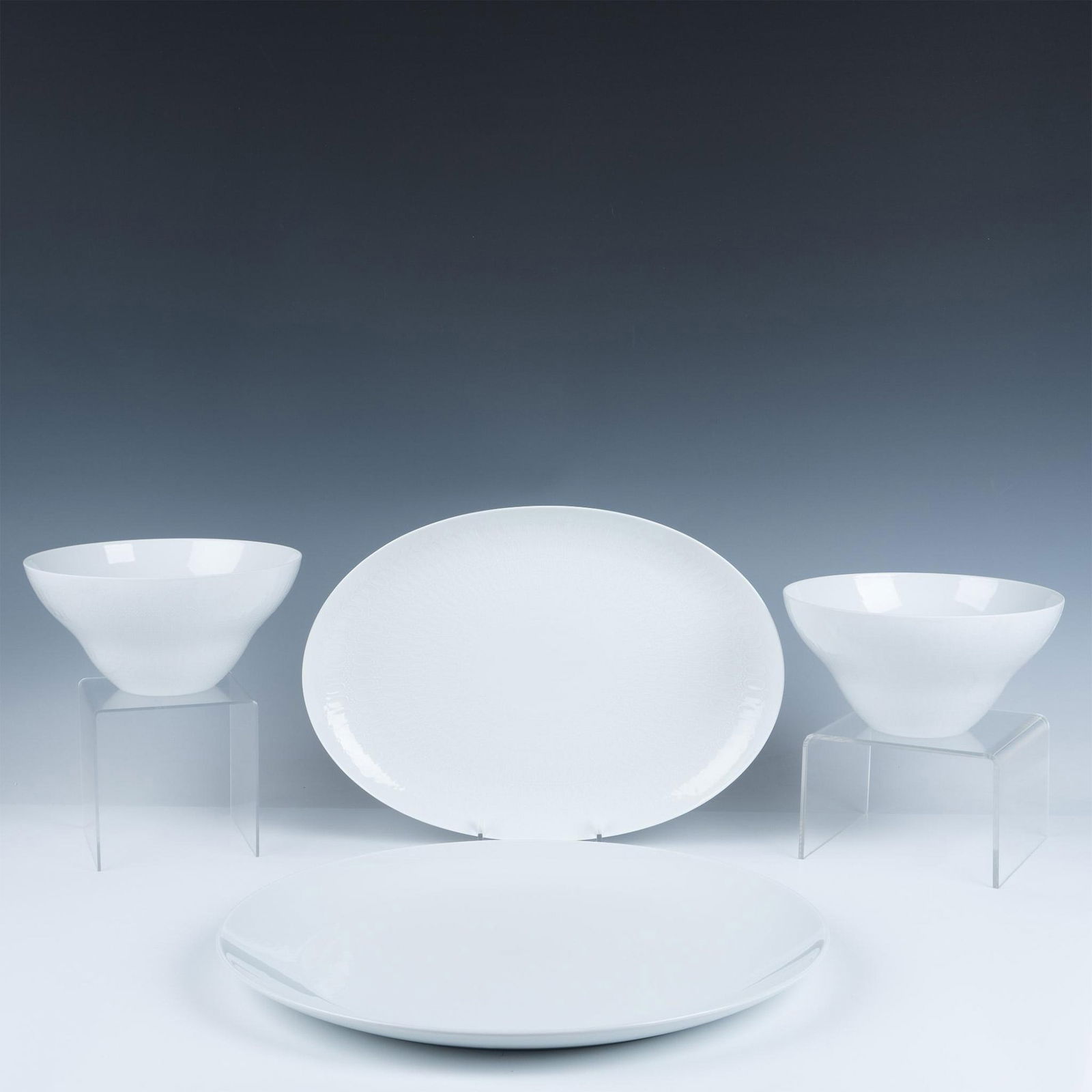 4pc Rosenthal & Pillivuyt Serveware Set: A set of four serveware pieces: 2 round bowls, 1 oval serving platter, and 1 large round serving platter. Rosenthal and Pillivuyt backstamps. Oval serving platter: 15"L x 10.5"W. Round serving platter