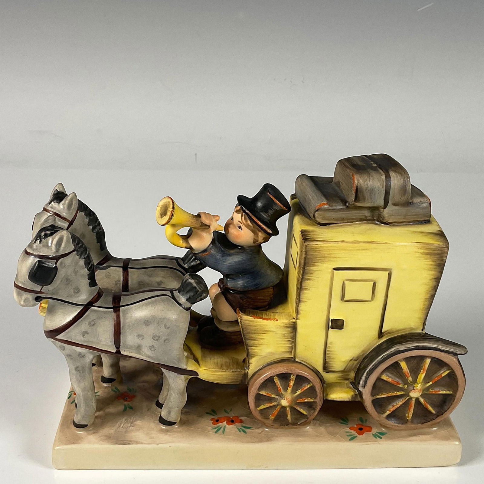 Goebel Hummel Porcelain Figure, the Mail is Here: Hand decorated figure of a figure of a boy blowing a trumpet to announce new incoming mail. Artist impressed signature in the base. Goebel Hummel backstamp. Issued: 20th century Dimensions: 6.25"L x 2