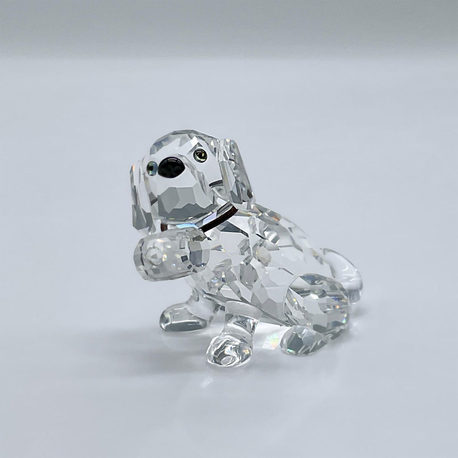 Swarovski Crystal Figurine, St Bernard Puppy: This adorable St Bernard puppy figure is made from clear crystal, with black eyes and a black nose. This item has its original box measuring 3.25"L x 3.25"W x 4.75"H. Swarovski acid mark. 201111. Arti