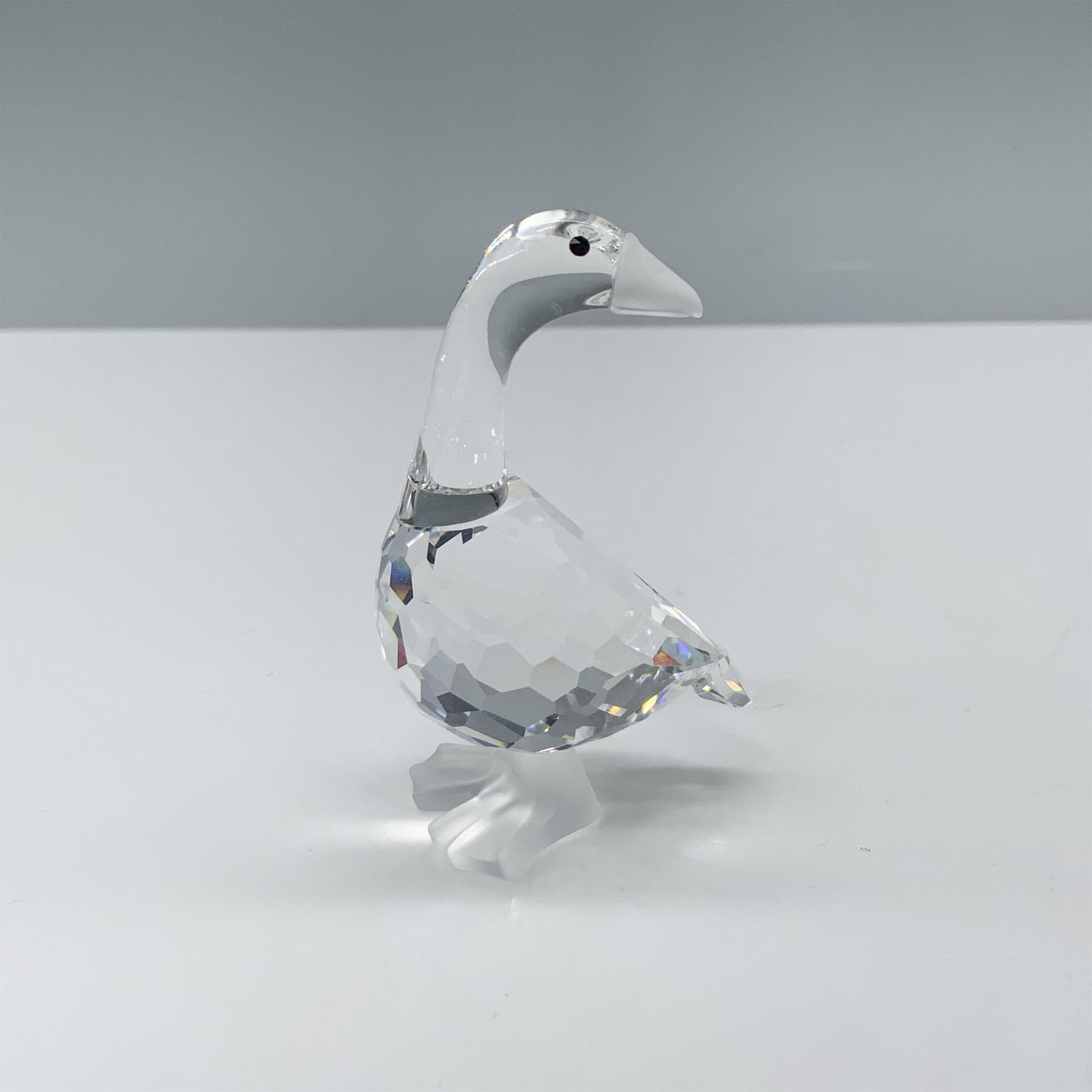 Swarovski Crystal Figurine, Mother Goose: Lovely crystal clear faceted figure that depicts a long necked goose with a frosted beak and feet. This figure was part of the Barnyard Friends collection. Swarovski backstamp. This item has its origi