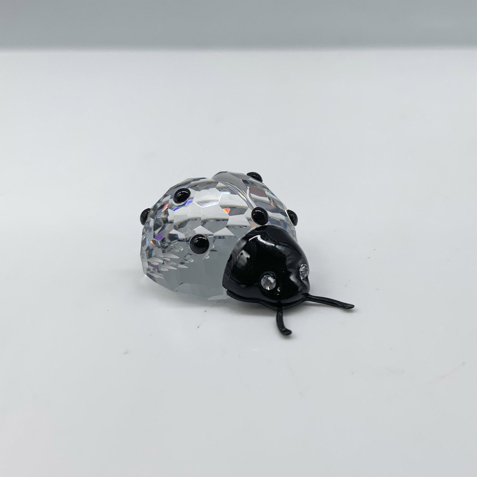 Swarovski Crystal Figurine, Ladybug: Fantastic crystal clear faceted figure that depicts a ladybug with contrasting black spots and a black head. This figure was part of the Secret Garden collection. A ladybug is a sign of good luck! Swa