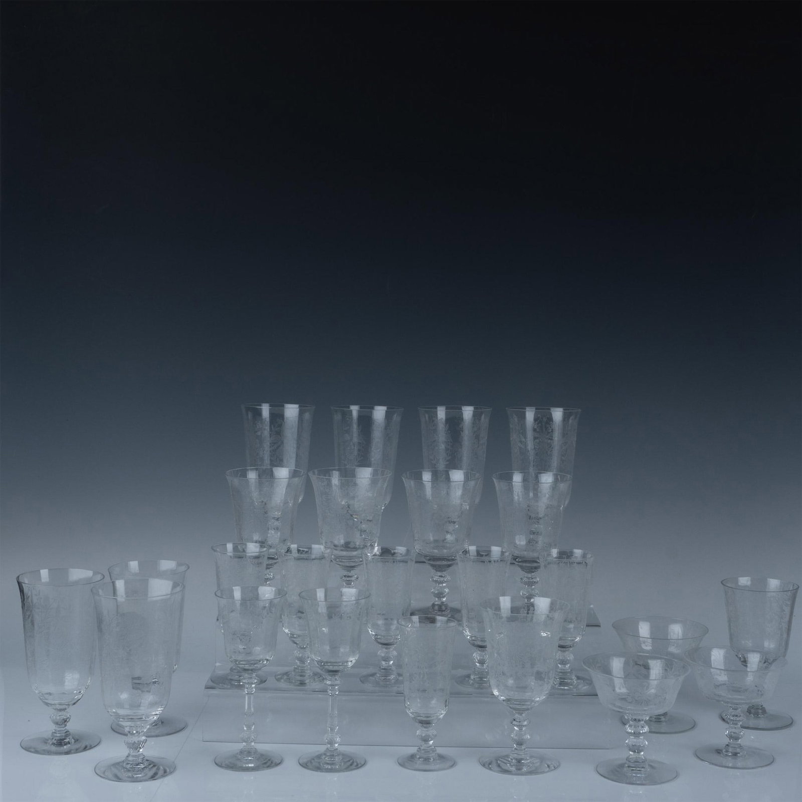 24pc Heisey Depression Glass Drinkware Collection, Orchid: This beautiful 24-piece Heisey Orchid set features elegant and timeless pieces, each adorned with the intricate Orchid pattern. The collection includes: three champagne glasses (3.75"H), seven iced te