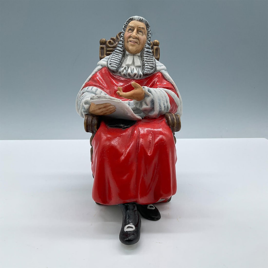 Judge - HN2443 - Royal Doulton Figurine: Matte finish. Modeled in vivid red, gray, and brown colors. Royal Doulton backstamp. Artist: Mary Nicoll Issued: 1976-1992 Dimensions: 5''L x 3.75''W x 6.5''H Manufacturer: Royal Doulton Country of O
