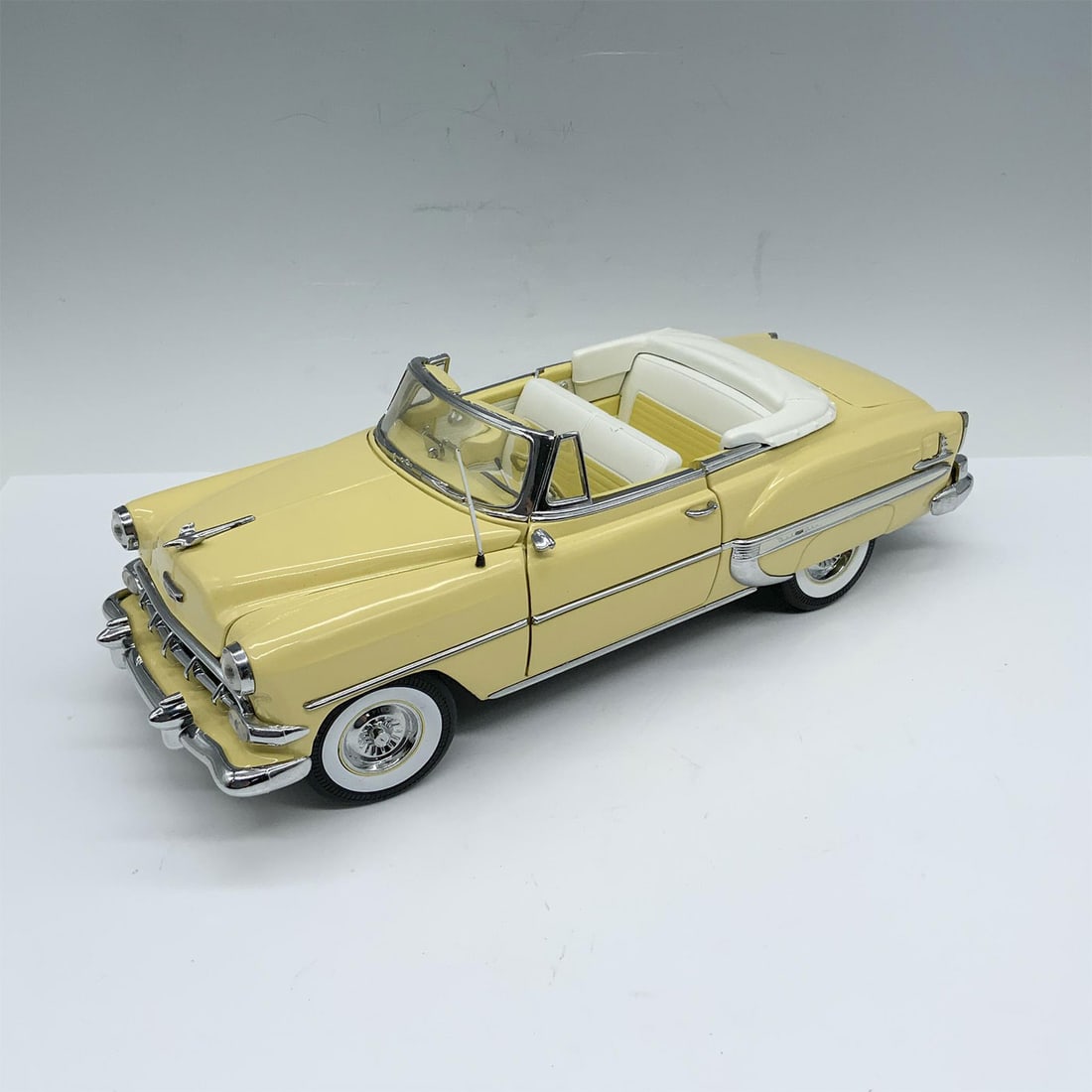 Sun Star 1954 Bell Air Toy Car: Splendid depiction of a pale yellow convertible with matching interiors and whitewall wheels. Driver and passenger doors open as well as the hood and the trunk. Sun Star backstamp. Issued: 20th centur