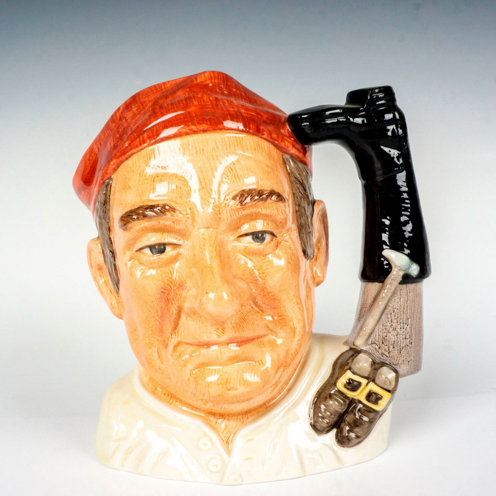 Bootmaker D6572 - Large - Royal Doulton Character Jug: Salmon cap, white shirt. Royal Doulton backstamp. Artist: David B. Biggs Issued: 1963 - 1983 Dimensions: 7.5"H Manufacturer: Royal Doulton Country of Origin: England