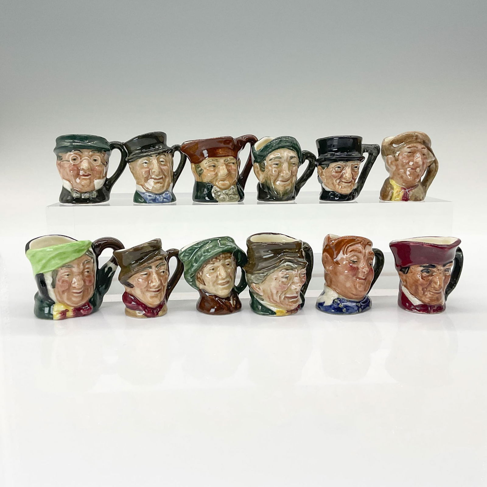 12pc Royal Doulton Tiny Toby Grouping: This collection includes Arriet D6256, Arry D6255, Auld Mac D6257, Cardinal D6258, Fat Boy D6142, John Peel D6259, Mr. Micawber D6143, Mr. Pickwick D6260, Old Charley D6144, Paddy D6145, Sairey Gamp D