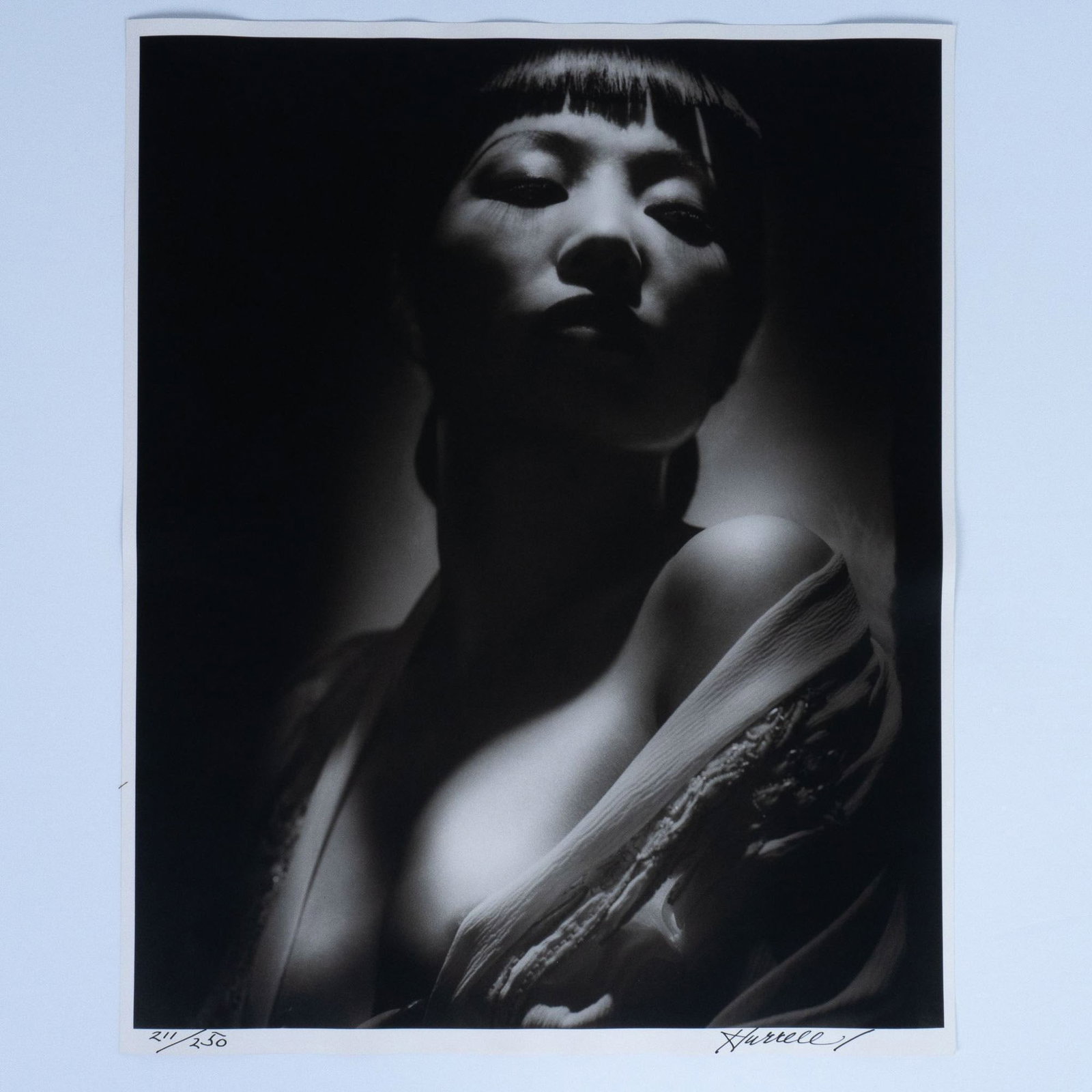 George Hurrell, Original Silver Gelatin Photograph, Signed - Featuring Anna May Wong, Edition: An original silver gelatin photograph on paper, capturing the timeless elegance of Anna May Wong, Hollywood's first Chinese-American movie star and an icon of the Golden Age of cinema. This striking p