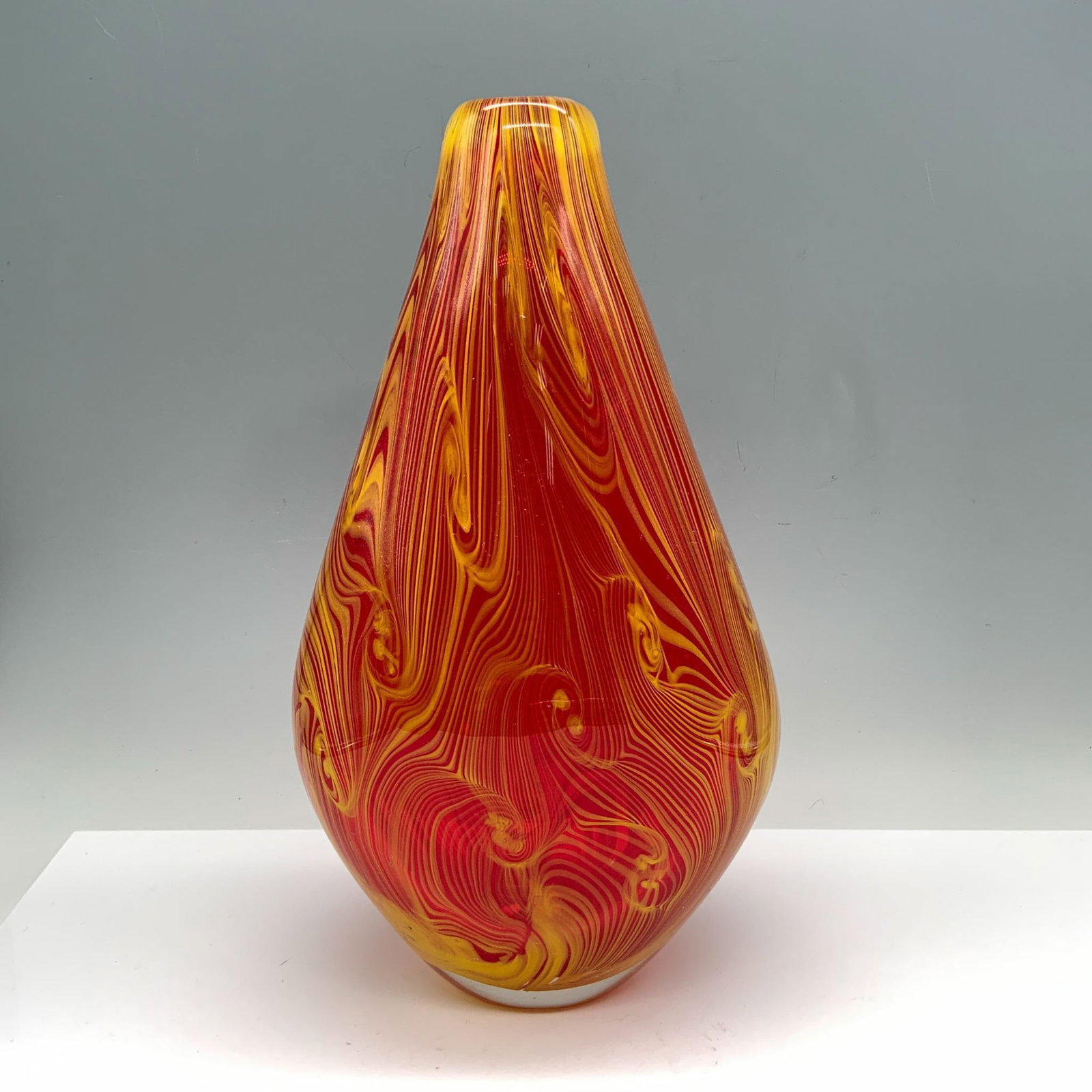 Art Glass Yellow and Red Swirled Trumpet Vase: Lovely art glass vase featuring an eye catching swirl pattern in bold shades of red and yellow. The vibrant colors flow together in a dynamic and energetic design, creating a sense of movement and war