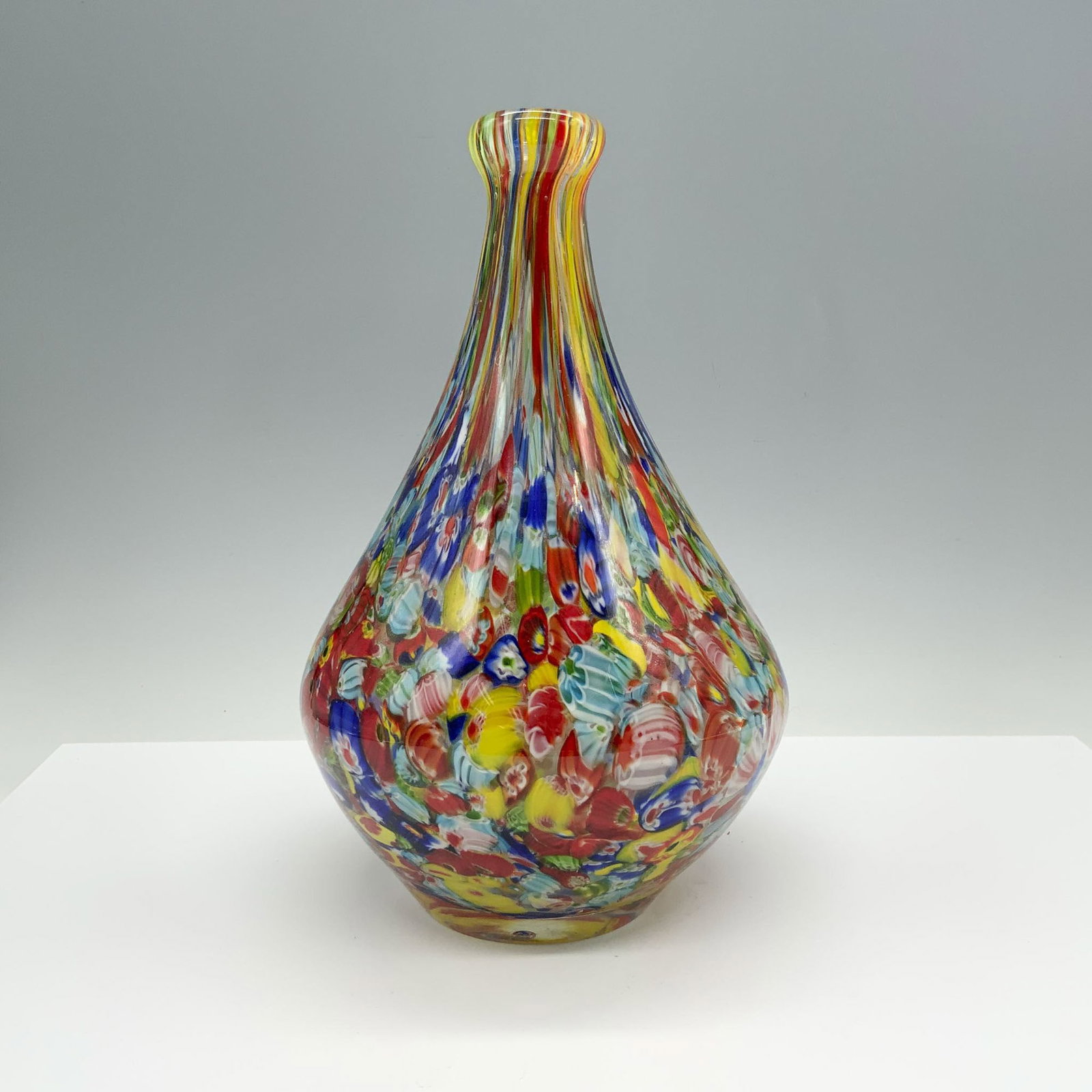 Art Glass Yellow and Red Confetti Trumpet Vase: This colorful piece showcases a harmonious blend of vibrant colors, with rich tones of golden yellow and red orange flowing seamlessly throughout the body of the vase. Ideal for display or as a center
