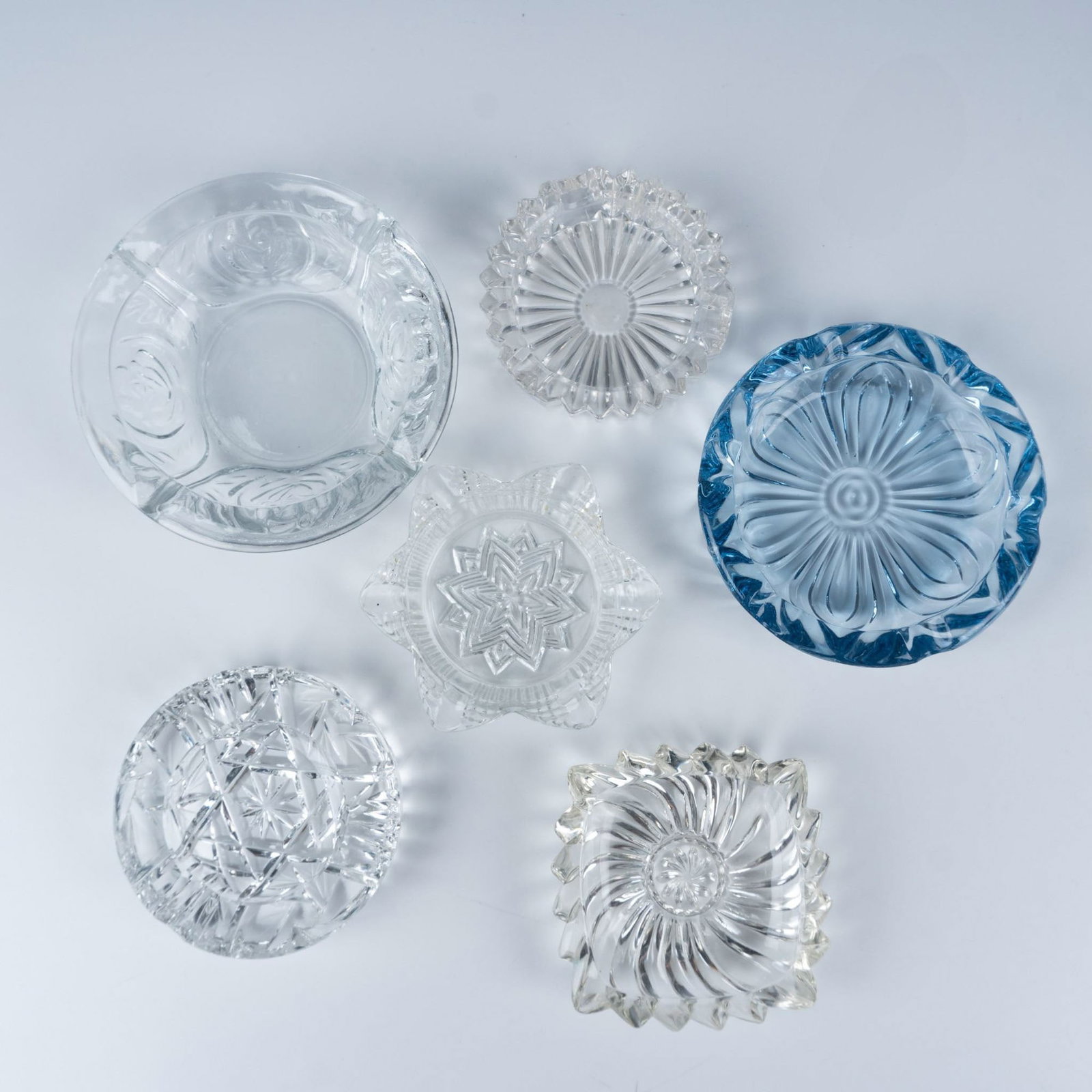 6pc Retro Clear Patterned Ashtrays: Elegant collection of lovely ash trays that consists of a square swirl pattered dish, a star shaped dish, a Bohemian styled etched dish, a sawtooth edged dish, a round dish with rose designs, and a mo