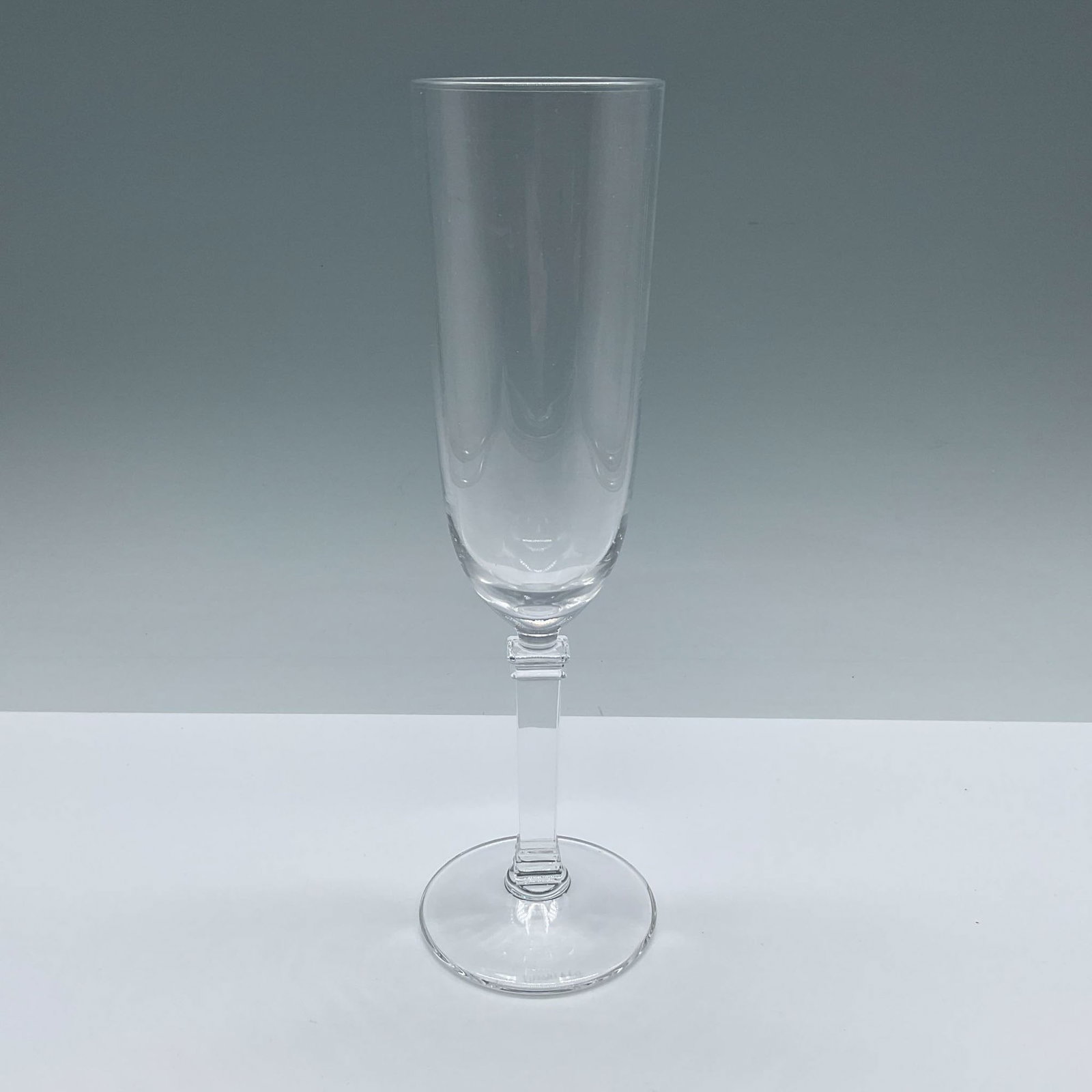 Tiffany & Co. Fluted Champagne Glass, Hampton: A clear, plain glassware with a column stem. Marked Tiffany & Co. Issued: 1994-2012 Dimensions: 2.75"W x 9"H Manufacturer: Tiffany & Co. Country of Origin: United States