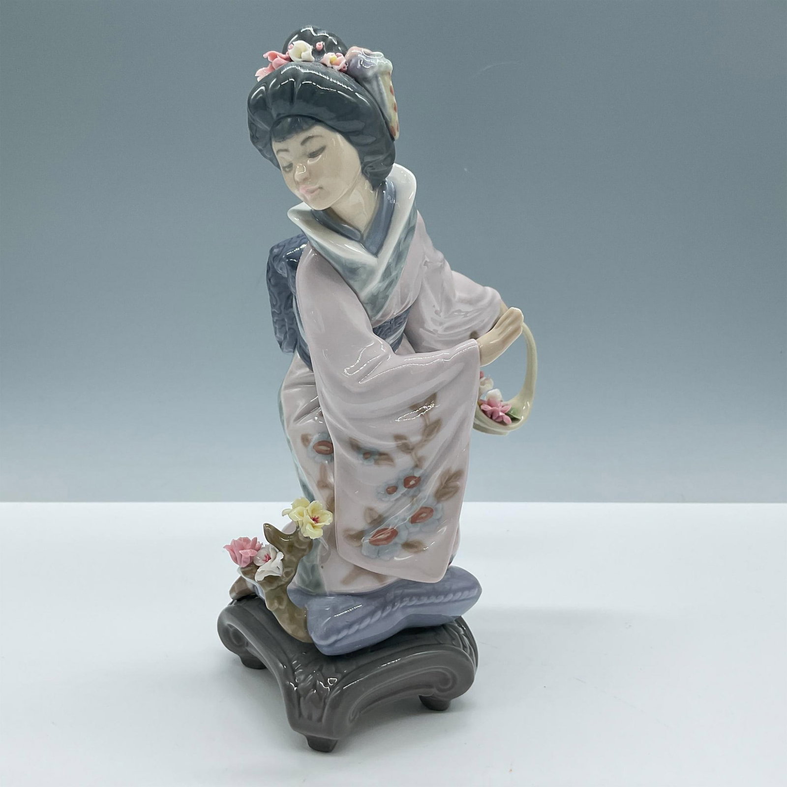 Michiko 1001447 - Lladro Porcelain Figurine: Glossy finish; Lladro backstamp. Artist: Salvador Debon Issued: 1983-2007 Dimensions: 8.75"H x 5.5"W Manufacturer: Lladro Country of Origin: Spain