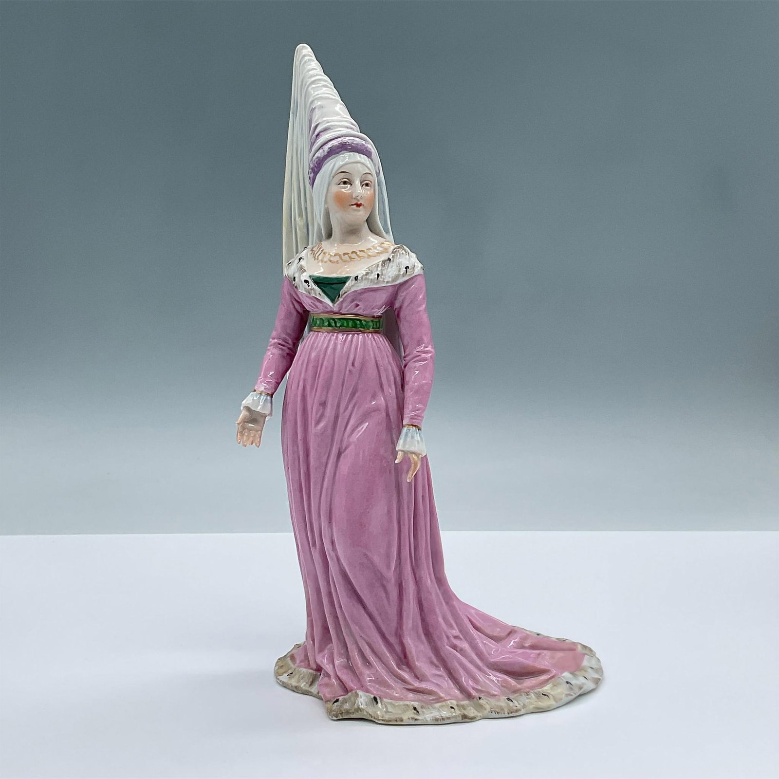 Dresden Porcelain Figurine, Medieval Lady: This porcelain figure features a woman fashioned in a pink medieval dress with a gilded gold neck piece. Dresden backstamp. Made in Germany backstamp. Issued: 20th century Dimensions: 5"L x 4.5"W x 9.