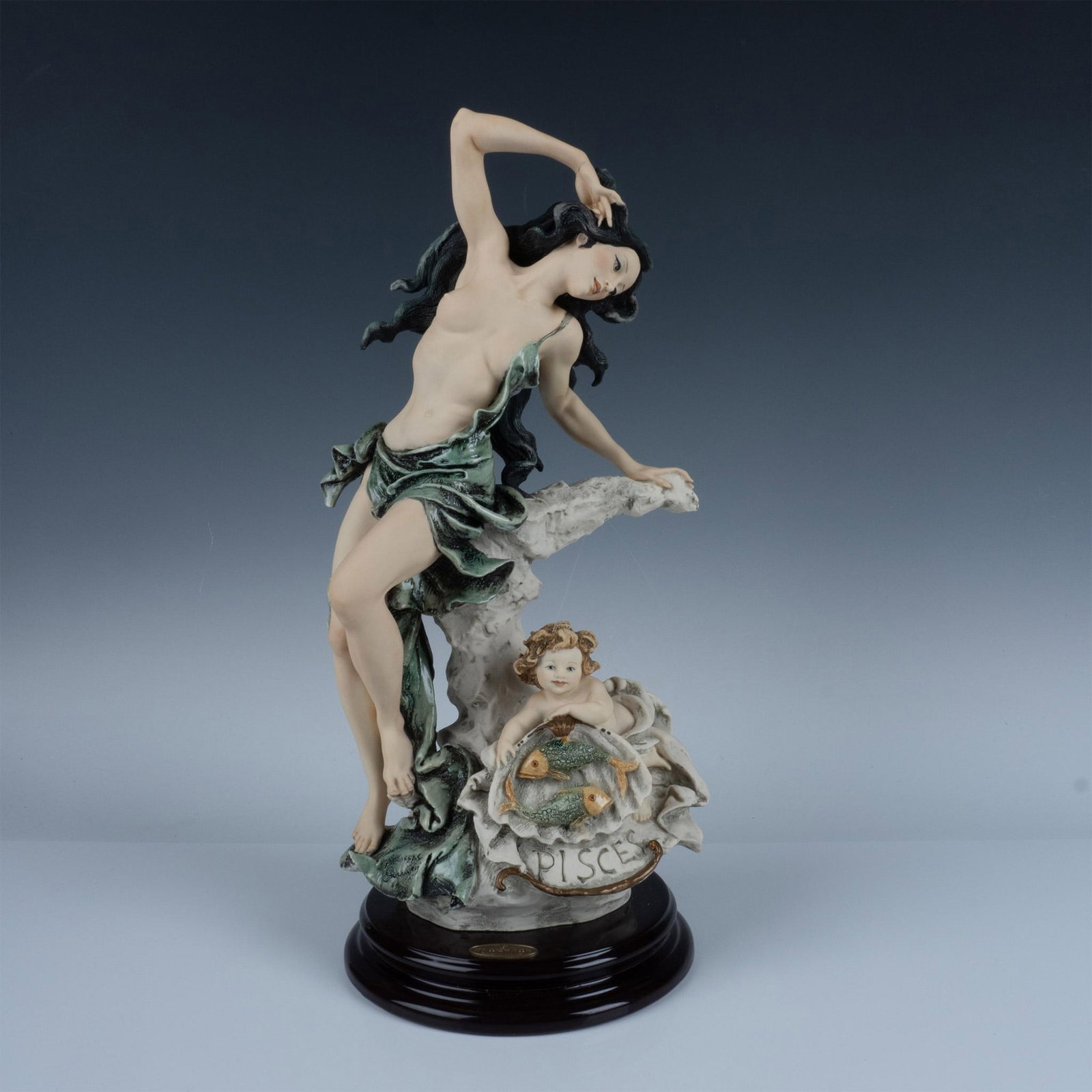 Florence Giuseppe Armani Zodiac Sculpture, Pisces 171C: Handcrafted sculpture representing the zodiac sign Pisces. This elegant piece features a serene woman adorned in flowing drapery, accompanied by two fish that embody harmony and fluidity. Sculpture is