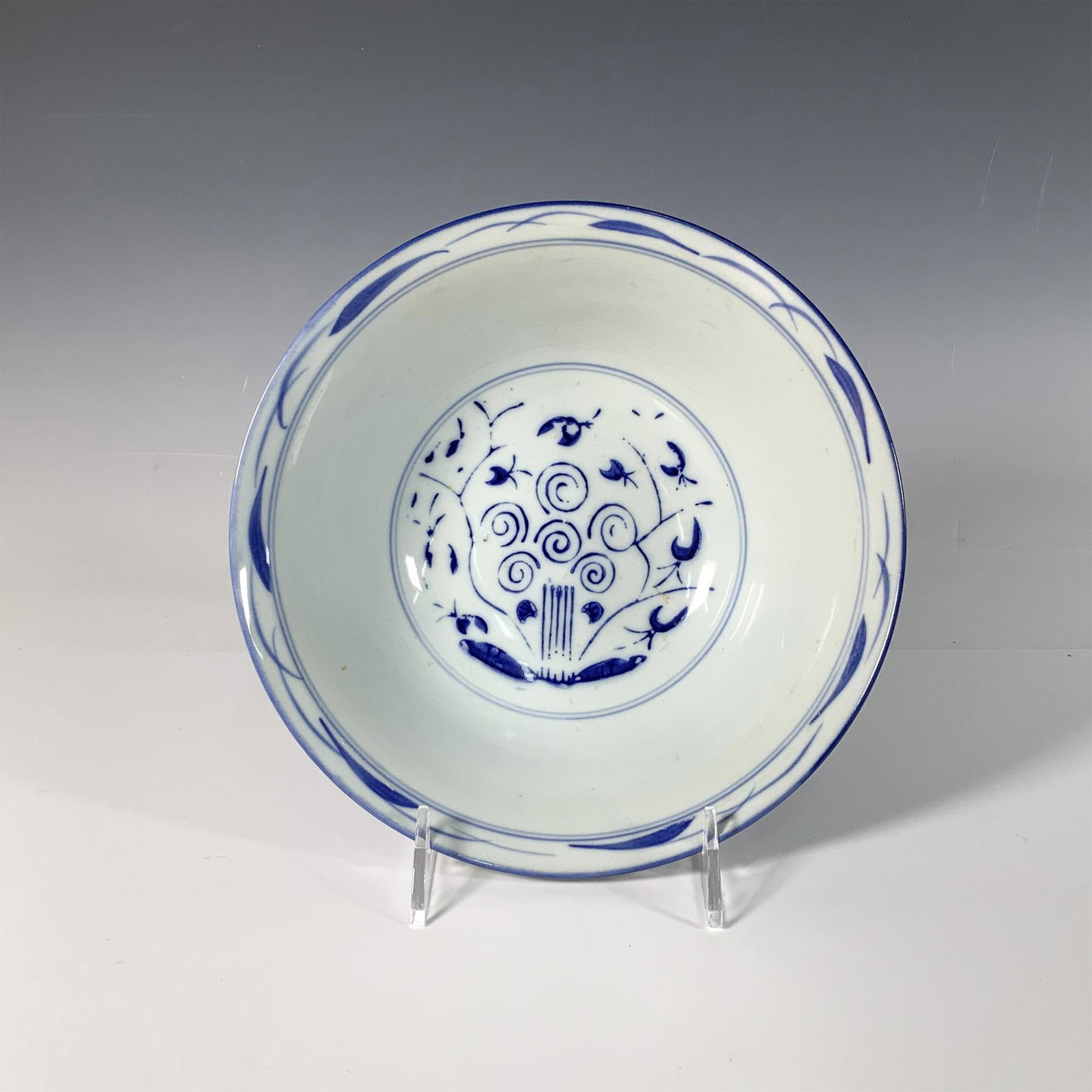 Chinese Blue and White Porcelain Serving Bowl: A charming flared bowl, hand-painted with intricate floral, geometric, and swirling patterns. Issued: c. 1950 Dimensions: 8.75"W x 3.75"H