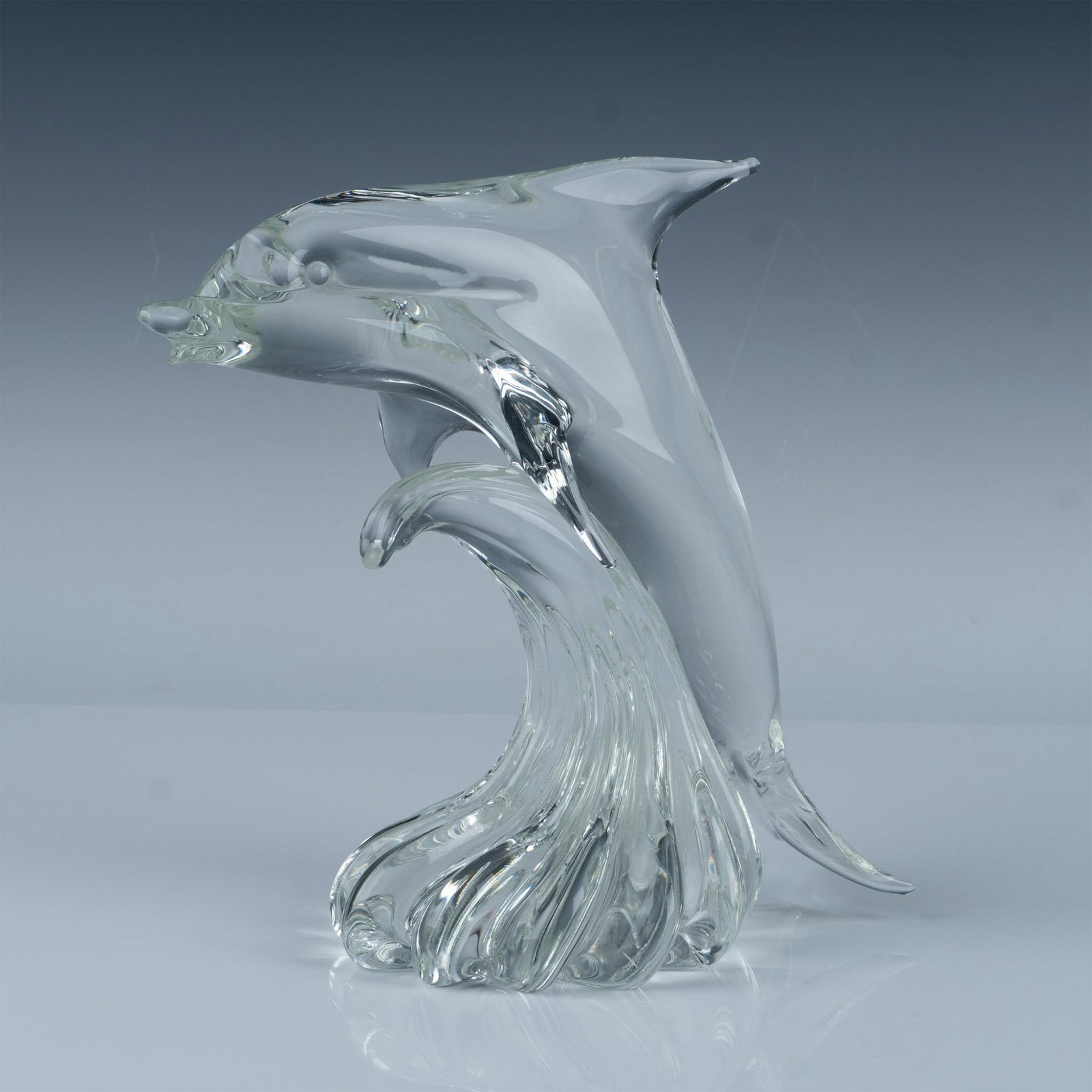 Art Glass Dolphin Sculpture, Signed: Beautifully crafted dolphin figurine that showcases the graceful form of a dolphin with smooth, flowing lines. Engraving at base likely reads Janet L. Issued: 20th century Dimensions: 12"L x 6.5"W x 1