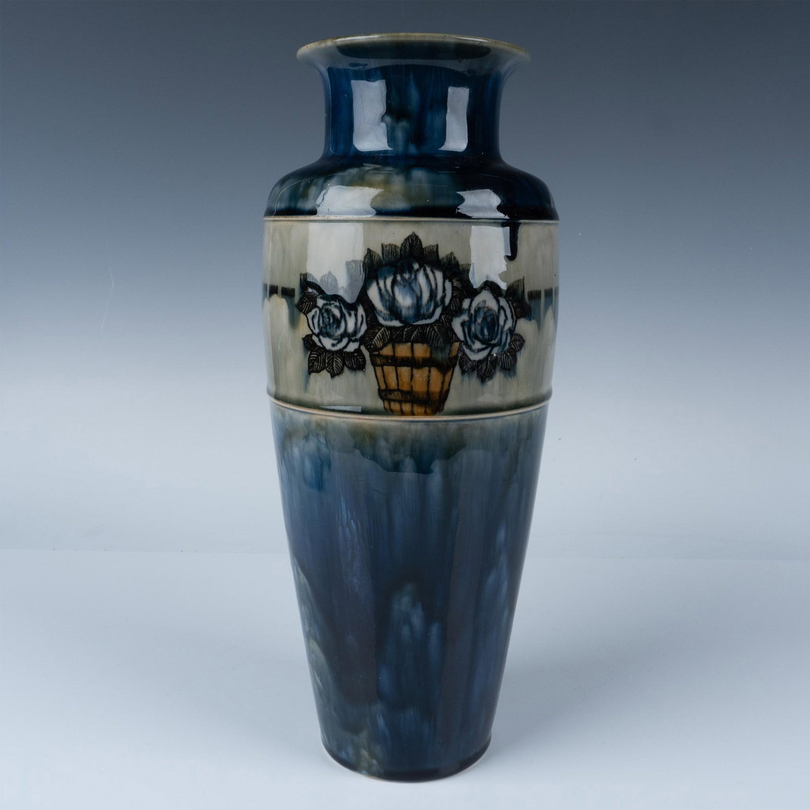 Royal Doulton Stoneware Art Nouveau Maud Bowden Vase: This piece features a basket of white roses set against a cobalt blue design. It is marked with the Royal Doulton backstamp and the numbers 7998 and 672. Artist: Maud Bowden Issued: 20th century Dimen