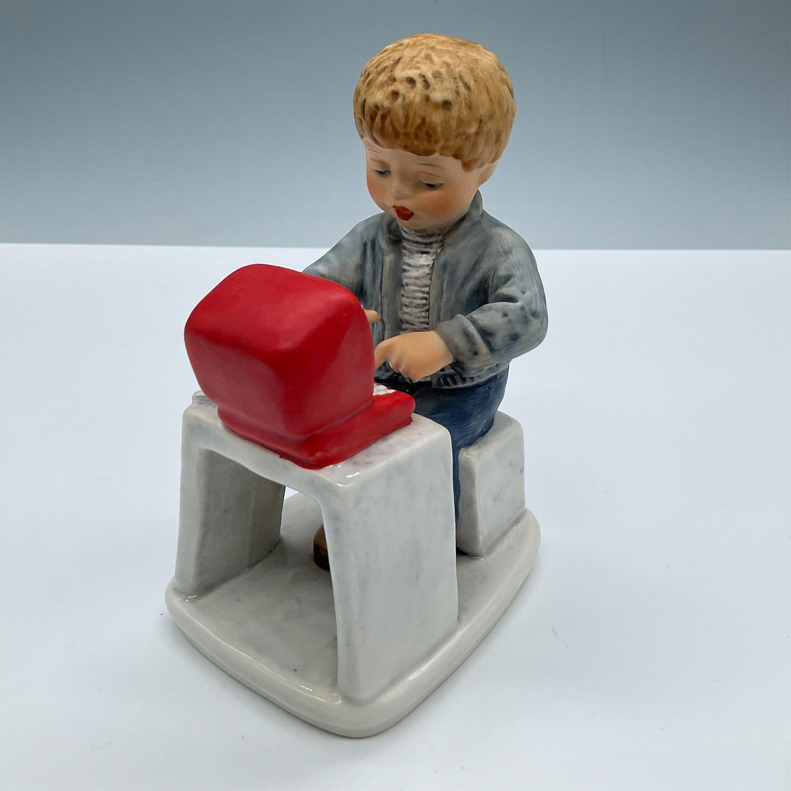 Goebel Hummel Figurine, Today's Children Boy on Computer: Matte porcelain. Features an adorable boy doing homework on his computer. Signed Frobek. Goebel Hummel Today's Children backstamp. Artist: Frobek Issued: 20th century Dimensions: 3.75''L x 3''W x 5.5'