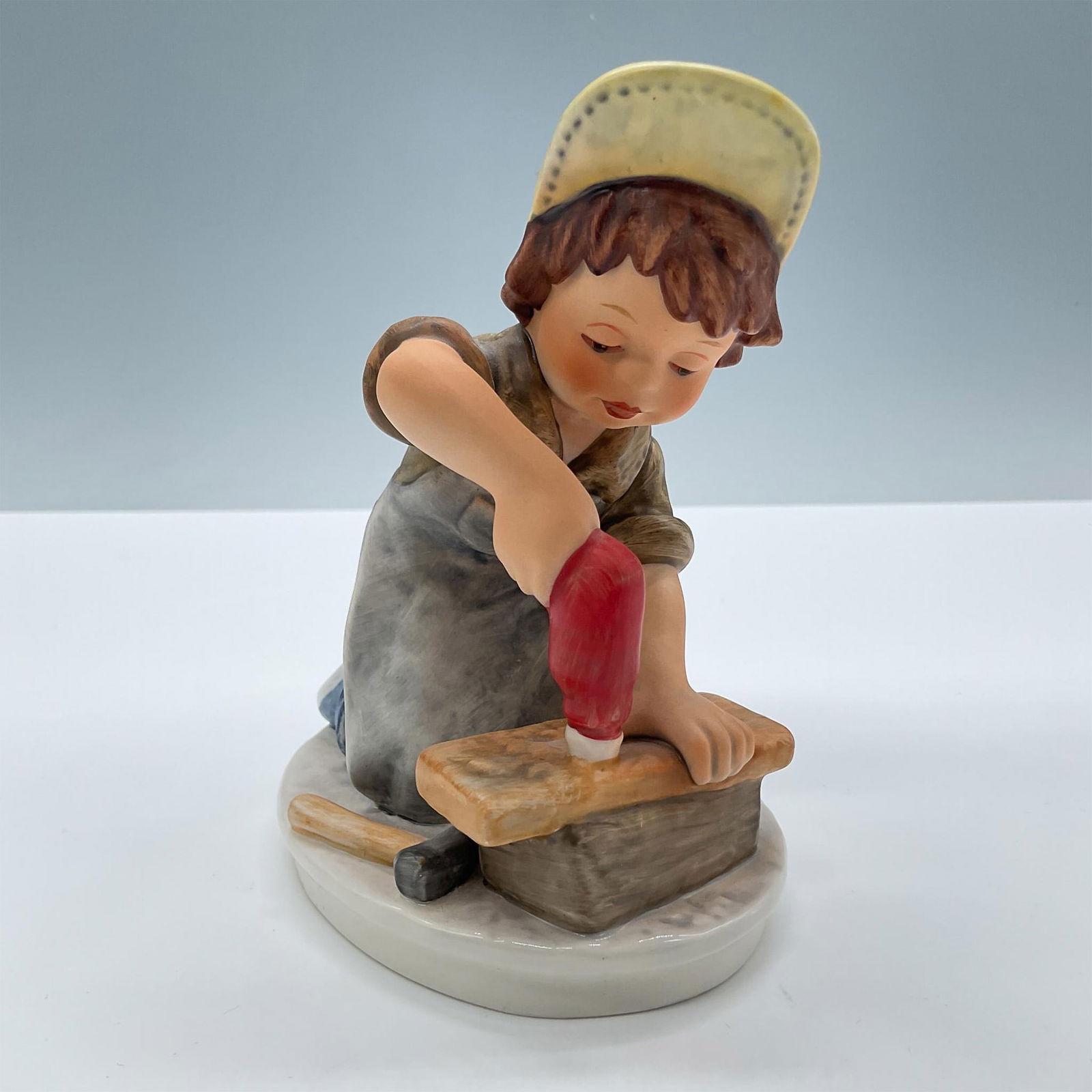 Goebel Hummel Figurine, Today's Children Helper Boy: Matte porcelain. Features a little carpenter boy. Signed Frobek. Goebel Hummel Today's Children backstamp. Issued: 20th century Dimensions: 3.75''L x 3''W x 4.75''H Manufacturer: Goebel Hummel Country