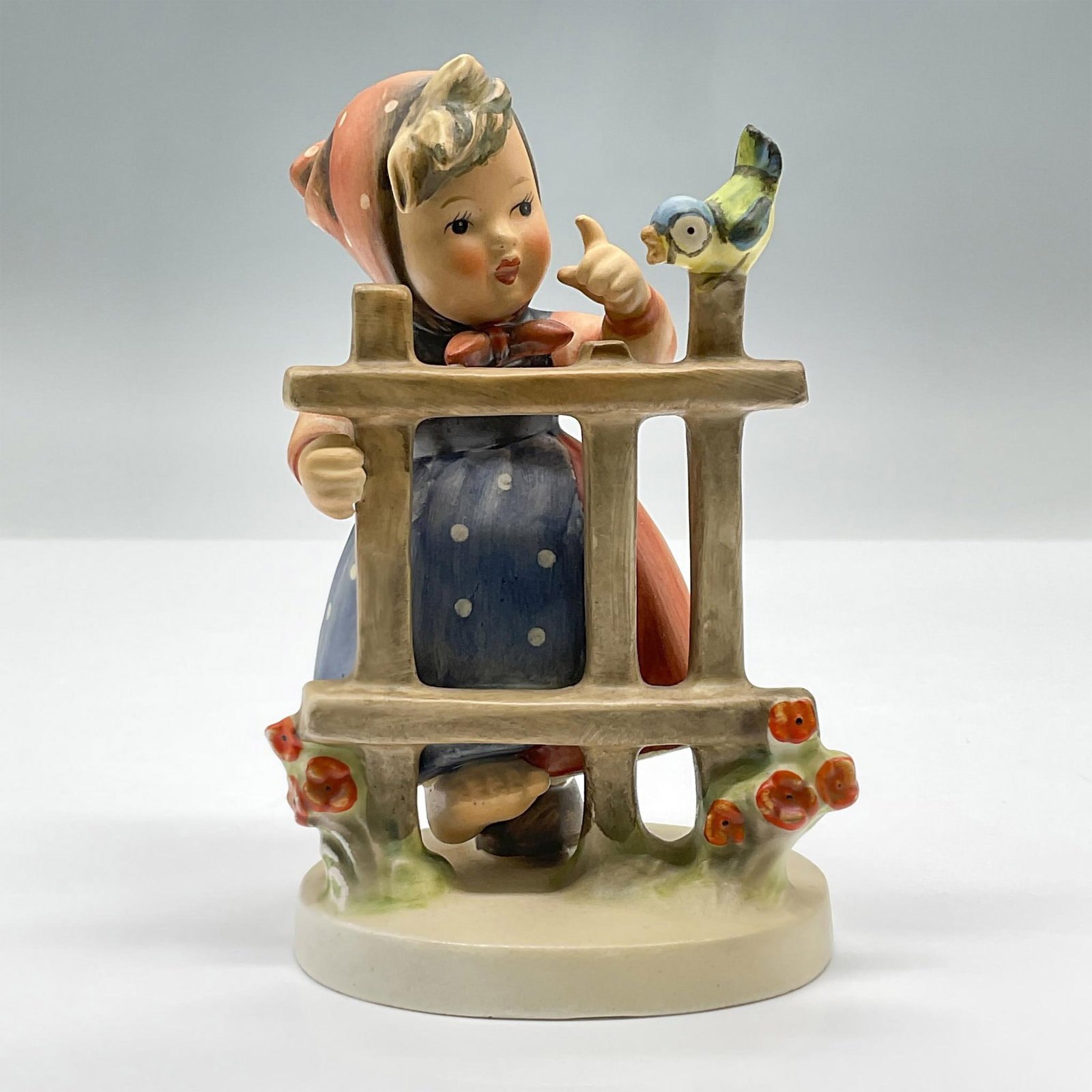 Goebel Hummel Porcelain Figurine, Sings of Spring: Adorable figure of a small girl near a fence with a bird perched upon it. Goebel Hummel backstamp. 203/I. Issued: 1945 Dimensions: 3.5"L x 3"W x 5.5"H Manufacturer: Goebel Hummel Country of Origin: Ge