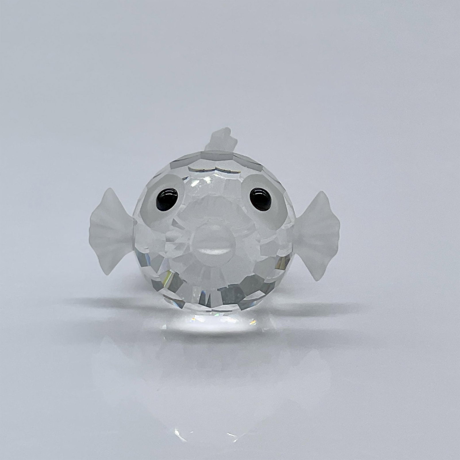 Swarovski Crystal Figurine, Miniature Blowfish: The smallest of the Swarovski blowfishes, features a clear crystal faceted body with frosted crystal fins, tail and mouth. This item has its original box measuring 3.25"L x 3.25"W x 2.5"H. Swarovski a