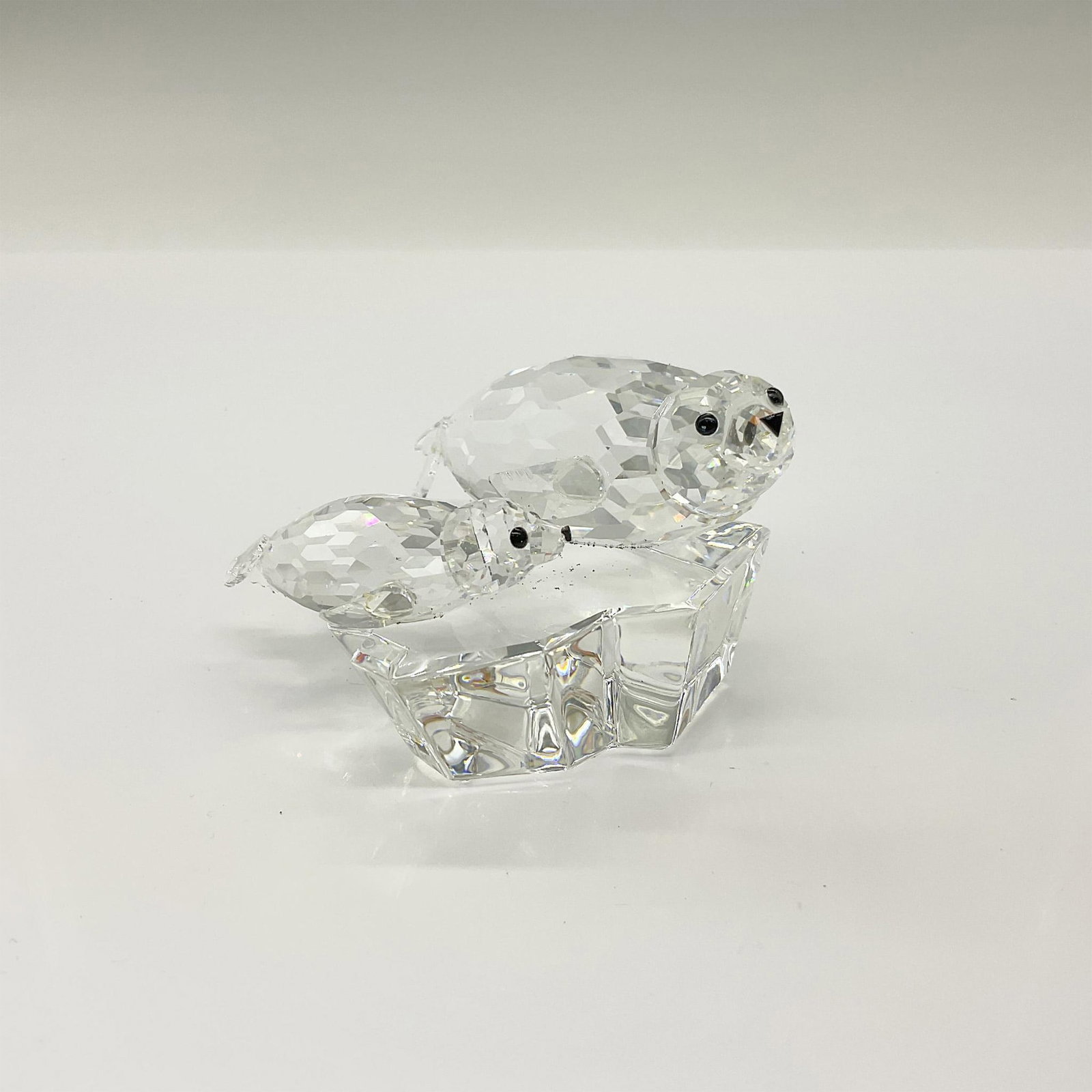 Swarovski Crystal Figurine, Save Me Seals: Annual edition part of the Mother and Child series and is made with jet crystal eyes. Swarovski etched backstamp. This item has its original box. Box measures: 7.75"H x 7.25" dia. Artist: Michael Stam