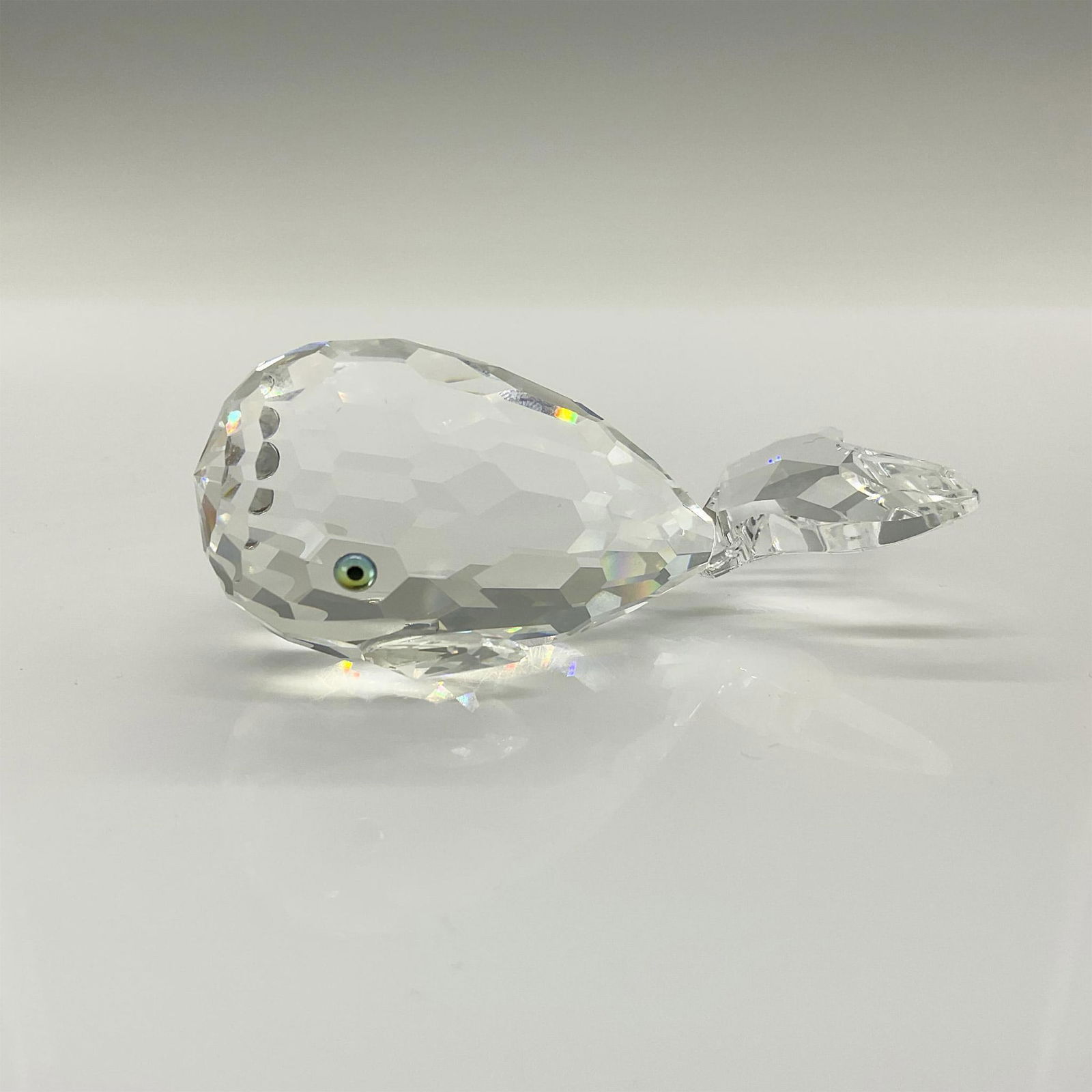 Swarovski Crystal Figurine, Whale Moby Dick or Smiley: This cheerful crystal whale is made from clear crystal and has green/black eyes and a frosted mouth. This item has its original box which measures 5"H x 3.25"dia. Swarovski etched backstamp. Artist: M