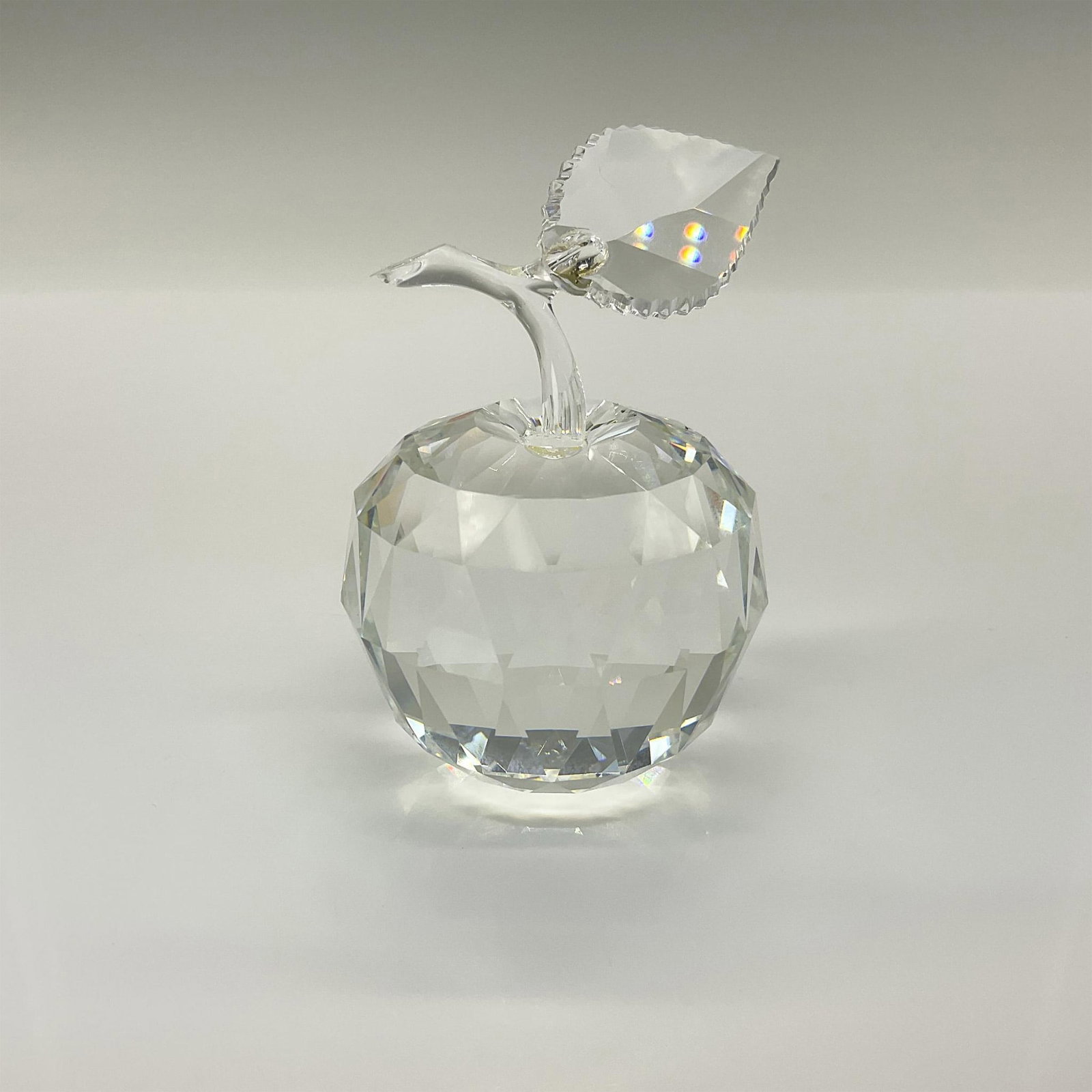 Swarovski Silver Crystal Figurine, Apple 160796: Part of the Sparkling Fruit series, this lead crystal apple is crafted from a combination of faceted and unfaceted clear crystal. Swarovski etched backstamp. This item has its original box. Box measur