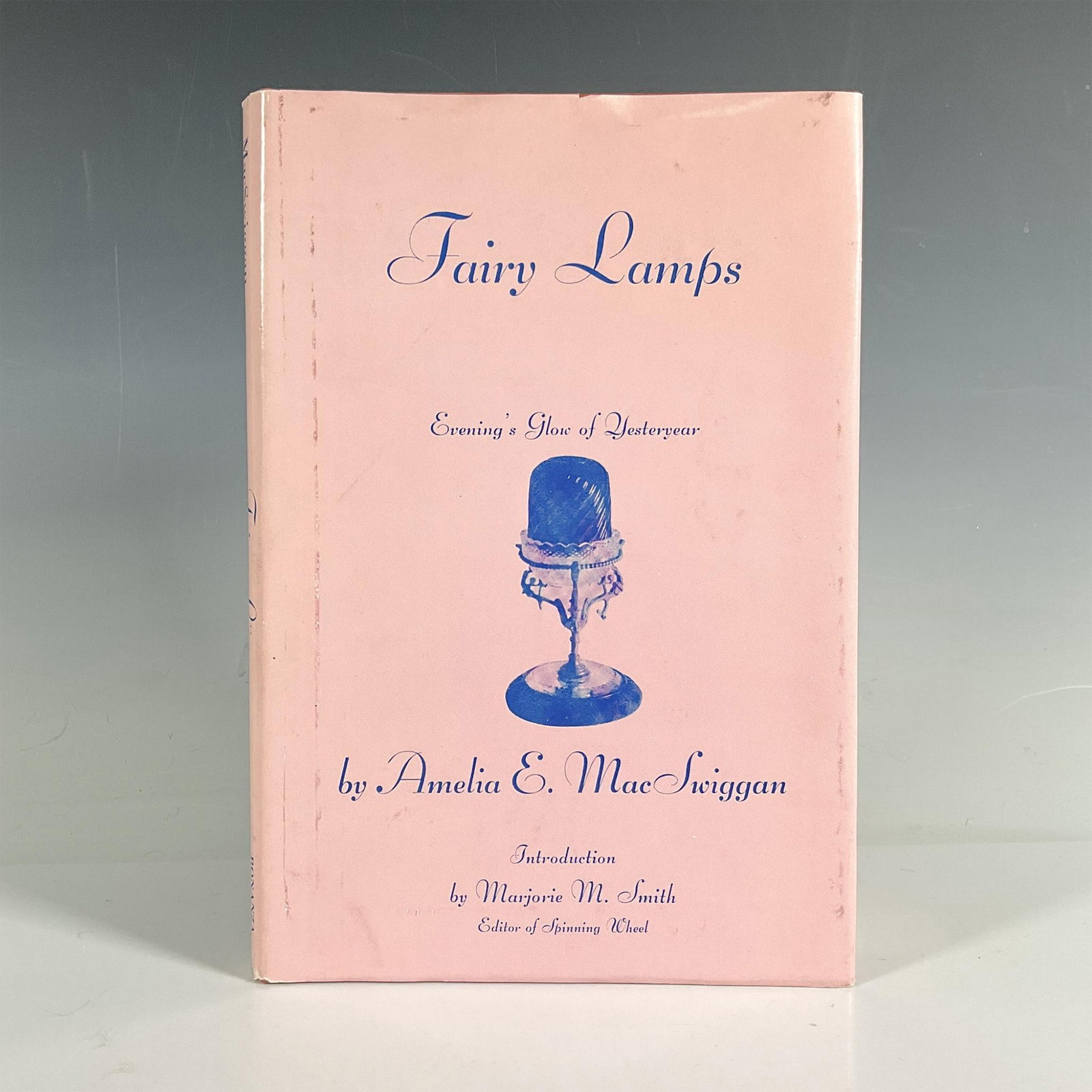 Amelia E. MacSwiggan Hardcover Book, Fairy Lamps: Full title is Fairy Lamps: Evening's Glow of Yesteryear. New York: Bonanza Books. 1962. Pink dust jacket with blue lettering. This 170-page book is a comprehensive and authoritative volume of the cand