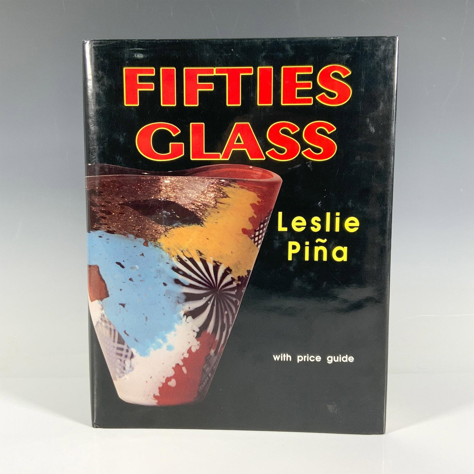Leslie Pina Hardcover Book, Fifties Glass With Price Guide: Atglen, PA: Schiffer Publishing Ltd. 1993. The dust jacket is black with photos of glass pieces. This 208-page book is a complete guide to glassware and glass collectibles from the 1950s with hundreds