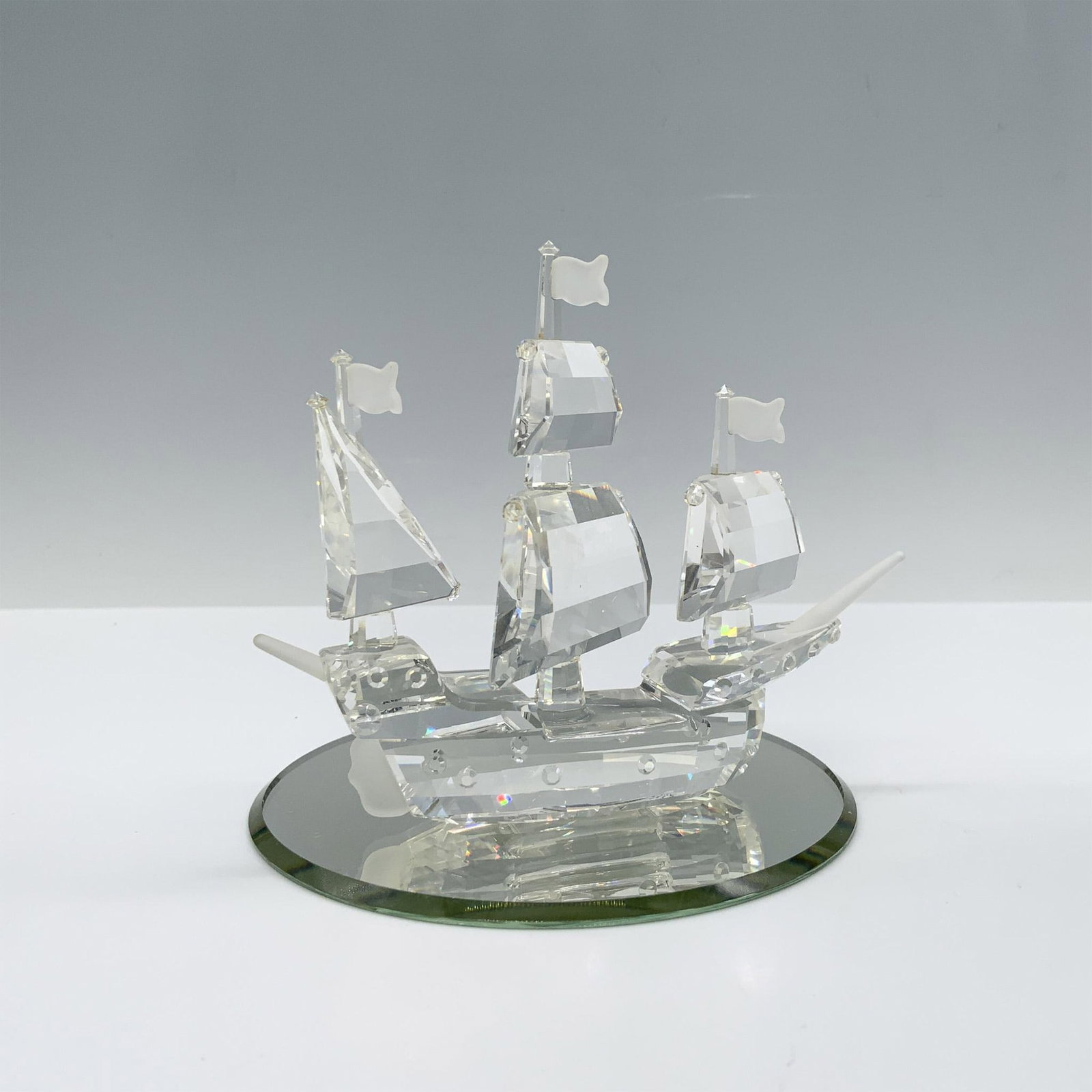 Swarovski Crystal Figurine, Santa Maria: Magnificent crystal clear faceted figure with patterned squares and frosted accents on the flags and bowsprit. This figure was part of the When We Were Young collection and includes a mirrored base. S