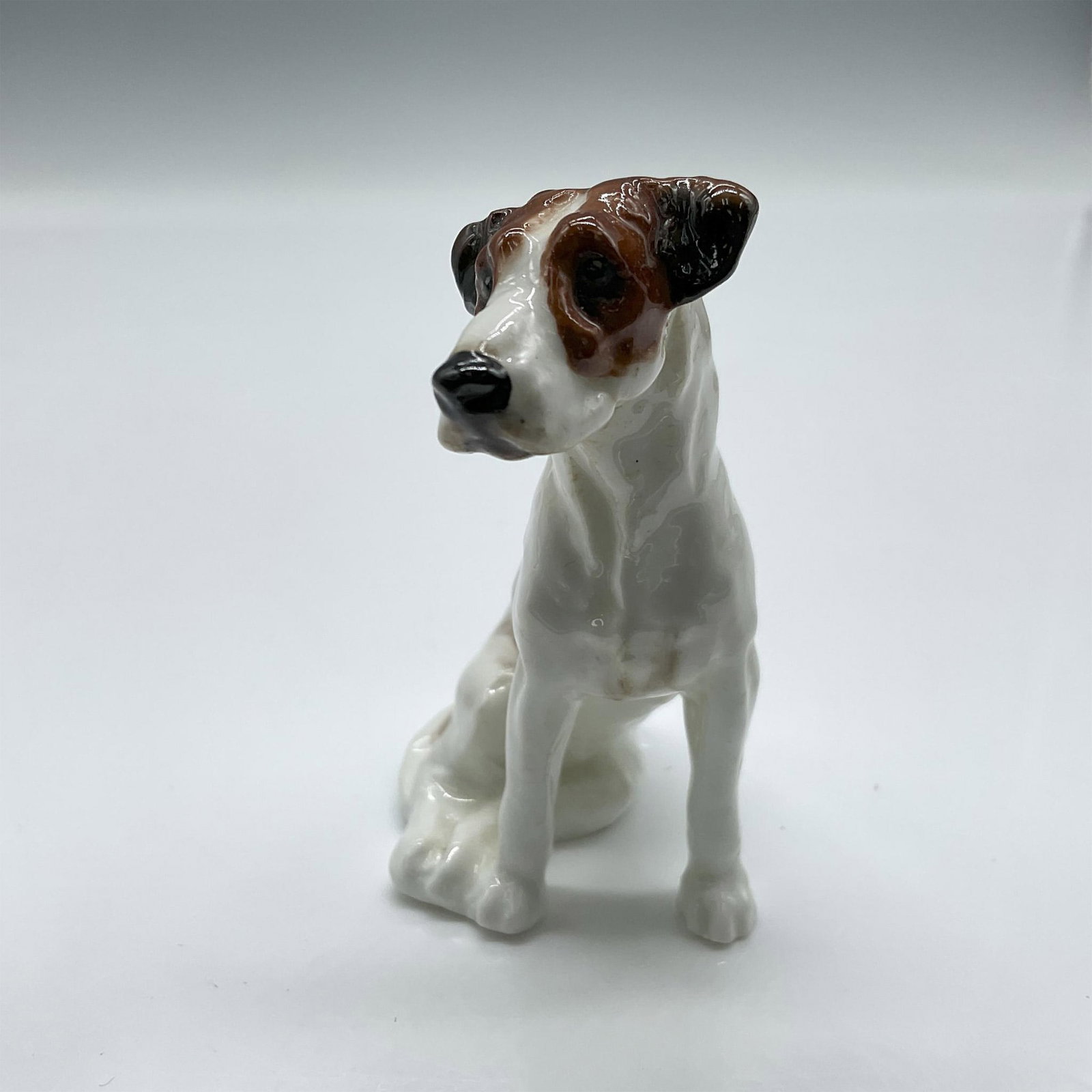 American Foxhound K7 - Royal Doulton Animal Figure: Scent hound with white coat and black and brown patches. Royal Doulton backstamp. Issued: 1931 - 1977 Dimensions: 2.5"H Manufacturer: Royal Doulton Country of Origin: England