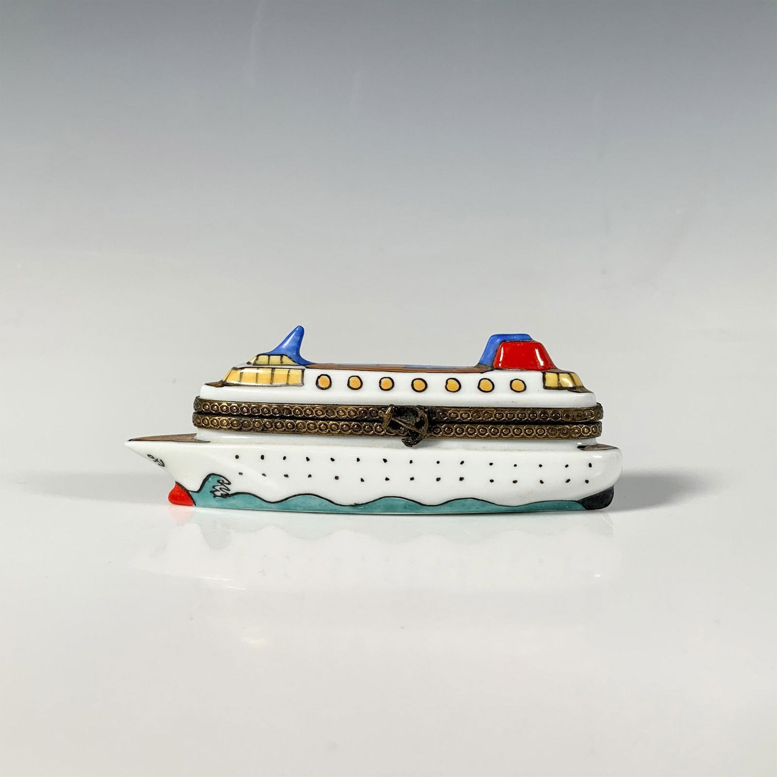 Limoges Porcelain Keepsake Box, Ocean Liner Chanille: This small whimsical treasure box is shaped like a large ship and hand-painted with vibrant colors and intricate details. It features a metal anchor closure and has an anchor with rope painted on the
