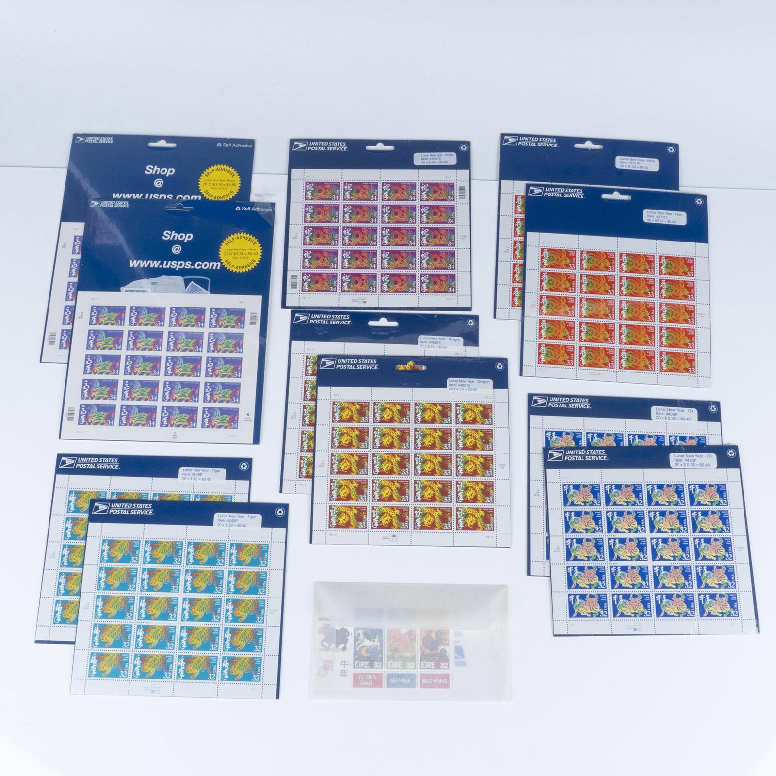 13 Sheets United States and Irish Chinese New Year Stamps: A collection of Lunar New Year theme postal stamps for the year 1996 to 2011. 11 sheets, from the United States Postal Service in original packaging features: (2) the Year of the Ox; (2) Year of the T