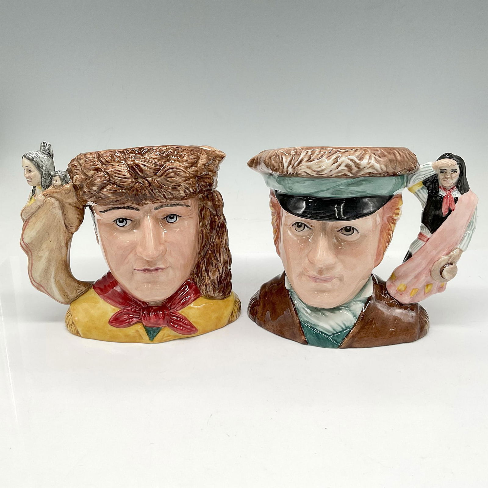 Meriwether Lewis and William Clark Pair D7235 & D7234 - Small - Royal Doulton Character Jug: Part of the American Icon Series, these 2 adventurers are replicated in the Character Jugs. Colored in brown, yellow, green and red. Royal Doulton backstamp. Largest piece: 5"L x 4"W x 5.25"H. Issued: