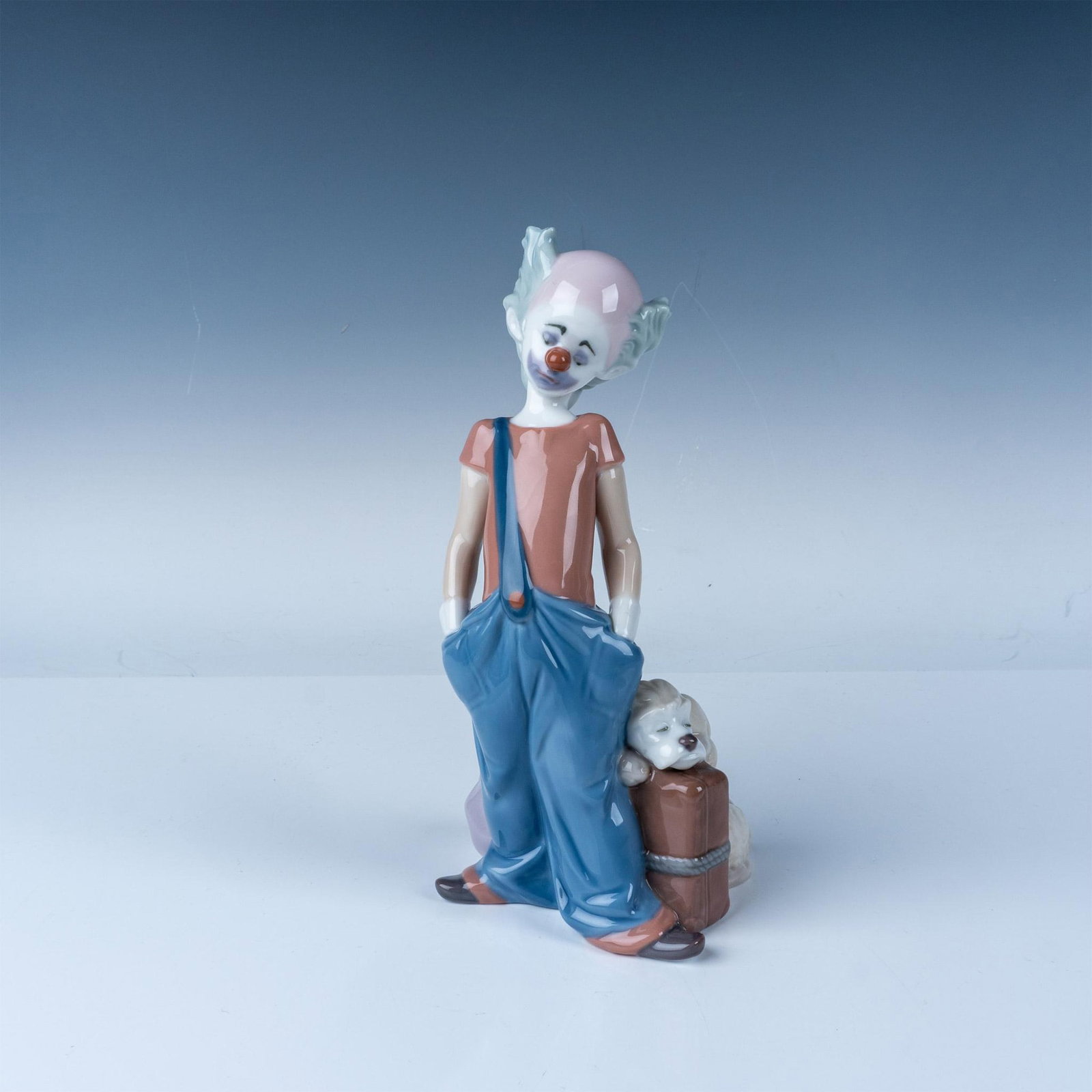Lladro Clown Event Figurine 1996 Limited Edition: Lladro porcelain figurine depicting a sad clown standing with a suitcase and dog, model number 6245. Handcrafted in Spain, this piece highlights Lladro's renowned artistry and attention to detail, par