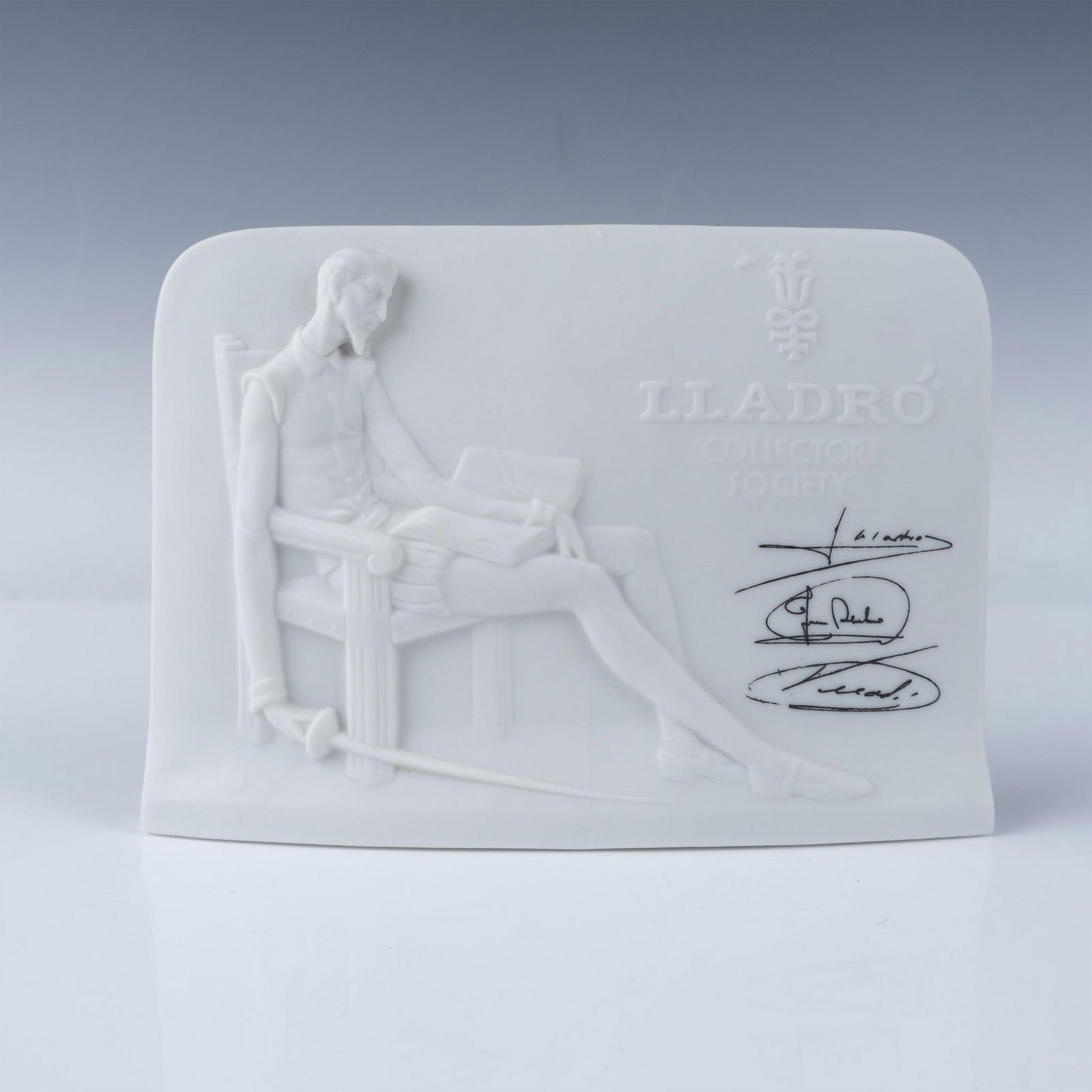 Signed Lladro Collectors Society Don Quixote Plaque: This exquisite Lladro porcelain plaque, issued exclusively to Collectors Society members in 1985, features a detailed relief of Don Quixote seated with a book and sword, embodying the timeless spirit