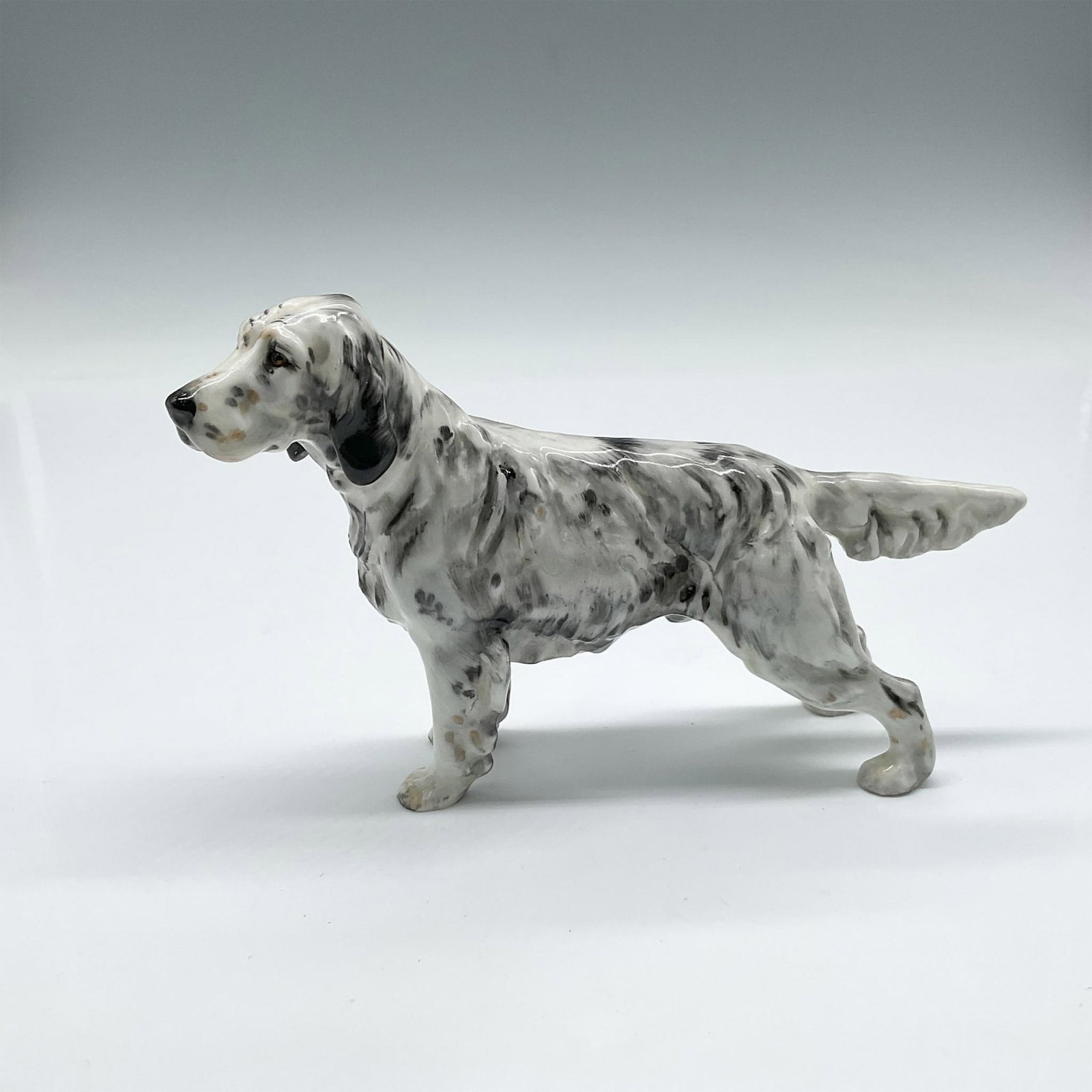 English Setter HN1050 - Royal Doulton Animal Figure: This gun dog is part of the Sporting dog series, colored in black and white, alert in his standing pose. Royal Doulton backstamp. Artist: Frederick Daws Issued: 1931 - 1985 Dimensions: 5.5"L x 1.5"W x