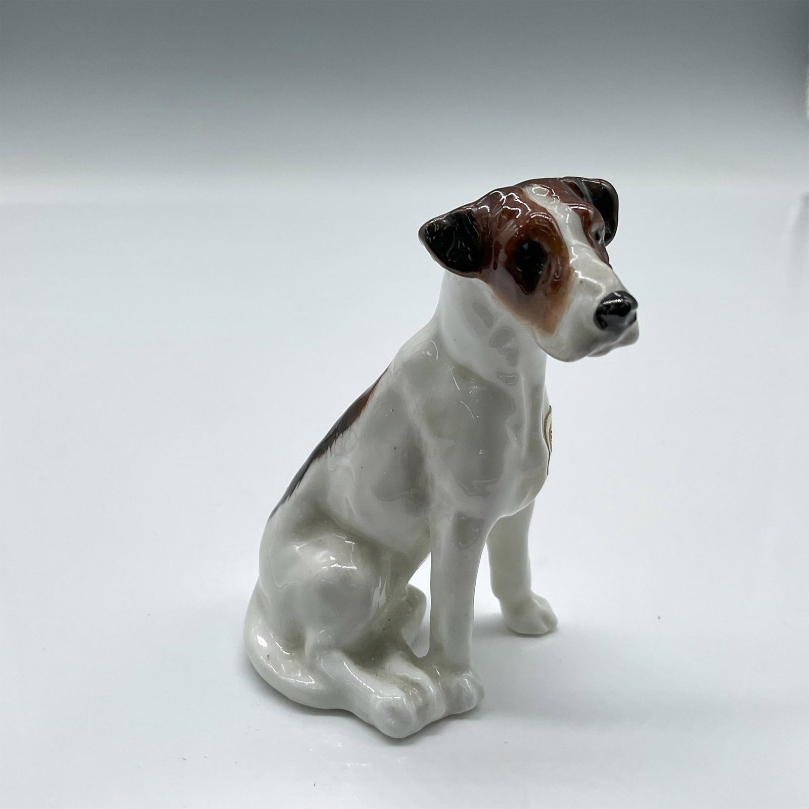 Royal Doulton Dog Figurine, American Foxhound K7: Scent hound with white coat and black and brown patches. Royal Doulton backstamp. Issued: 1931 - 1977 Dimensions: 2.5"H Manufacturer: Royal Doulton Country of Origin: England