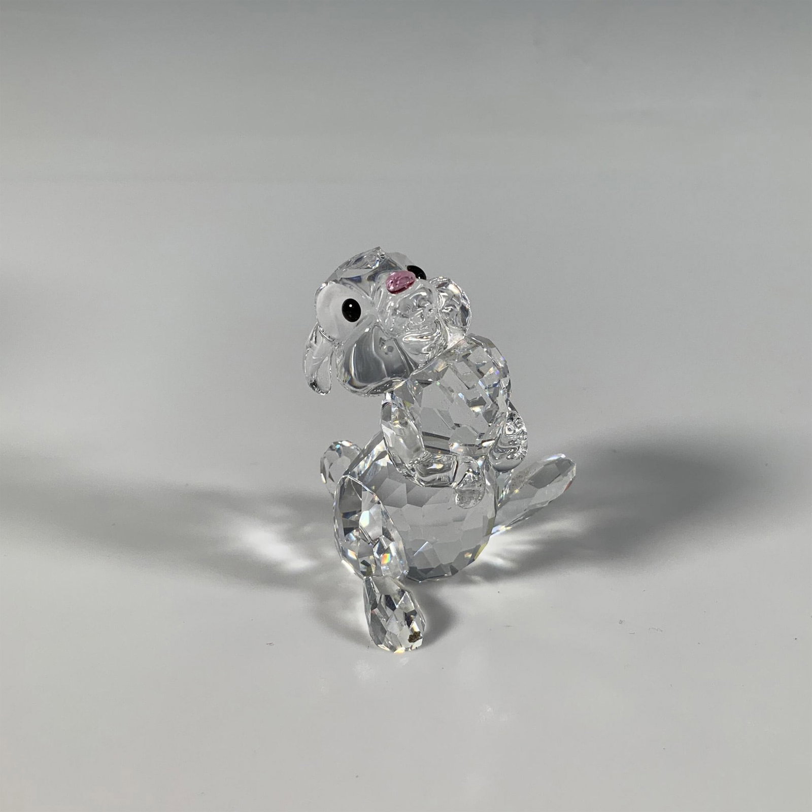 Swarovski Crystal Figurine, Thumper Rabbit: This adorable bunny figure, part of the Disney Bambi series, is crafted from faceted crystal with a combination of smooth and frosted features, accented by black eyes and a delicate pink nose. Swarovs