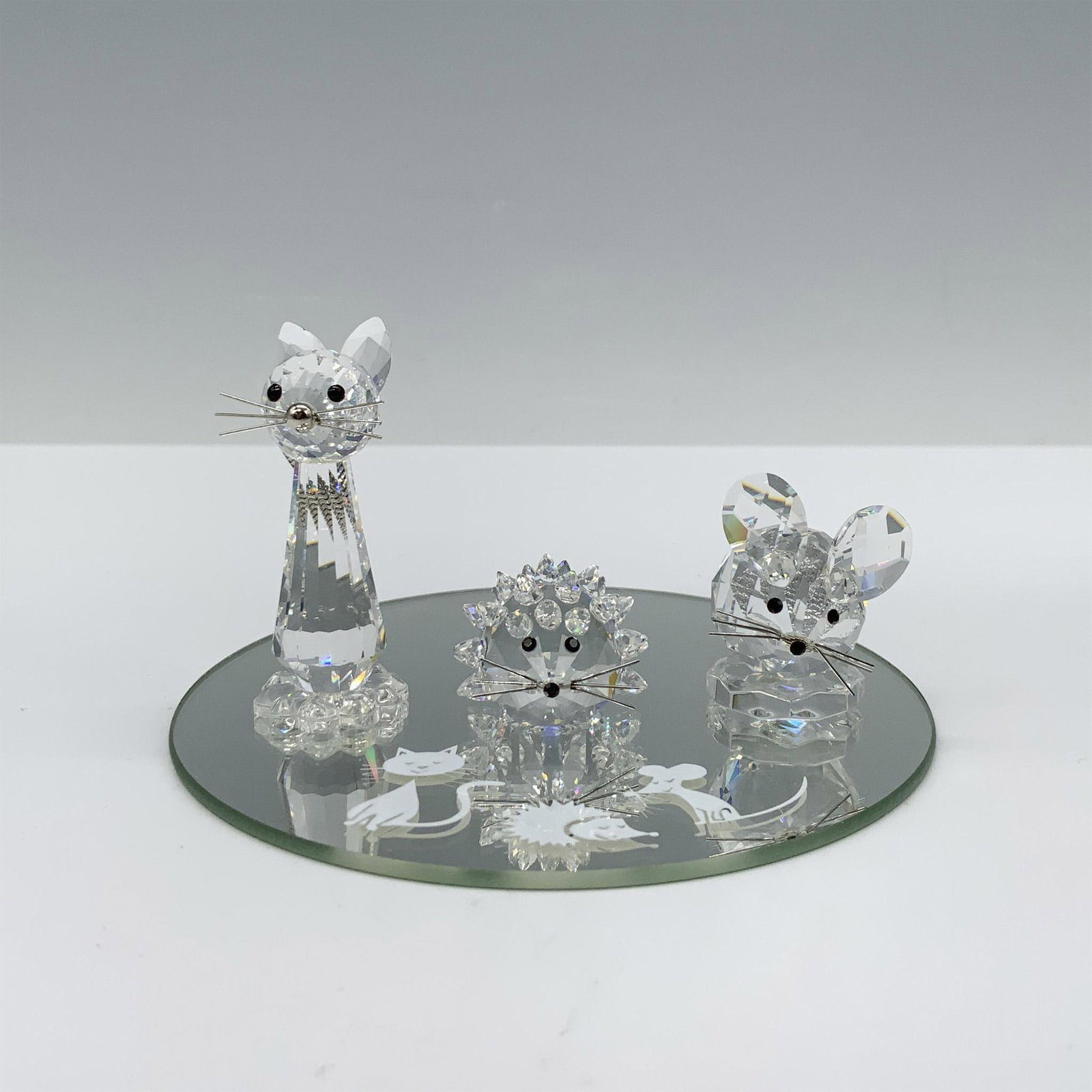 Swarovski Crystal Figurines, Starter Trio Animals: Adorable trio of clear crystal faceted animals with metal whiskers, black crystal eyes and nose that includes a cat, mouse, and hedgehog. Comes with mirrored base that contains animal etchings. Swarov