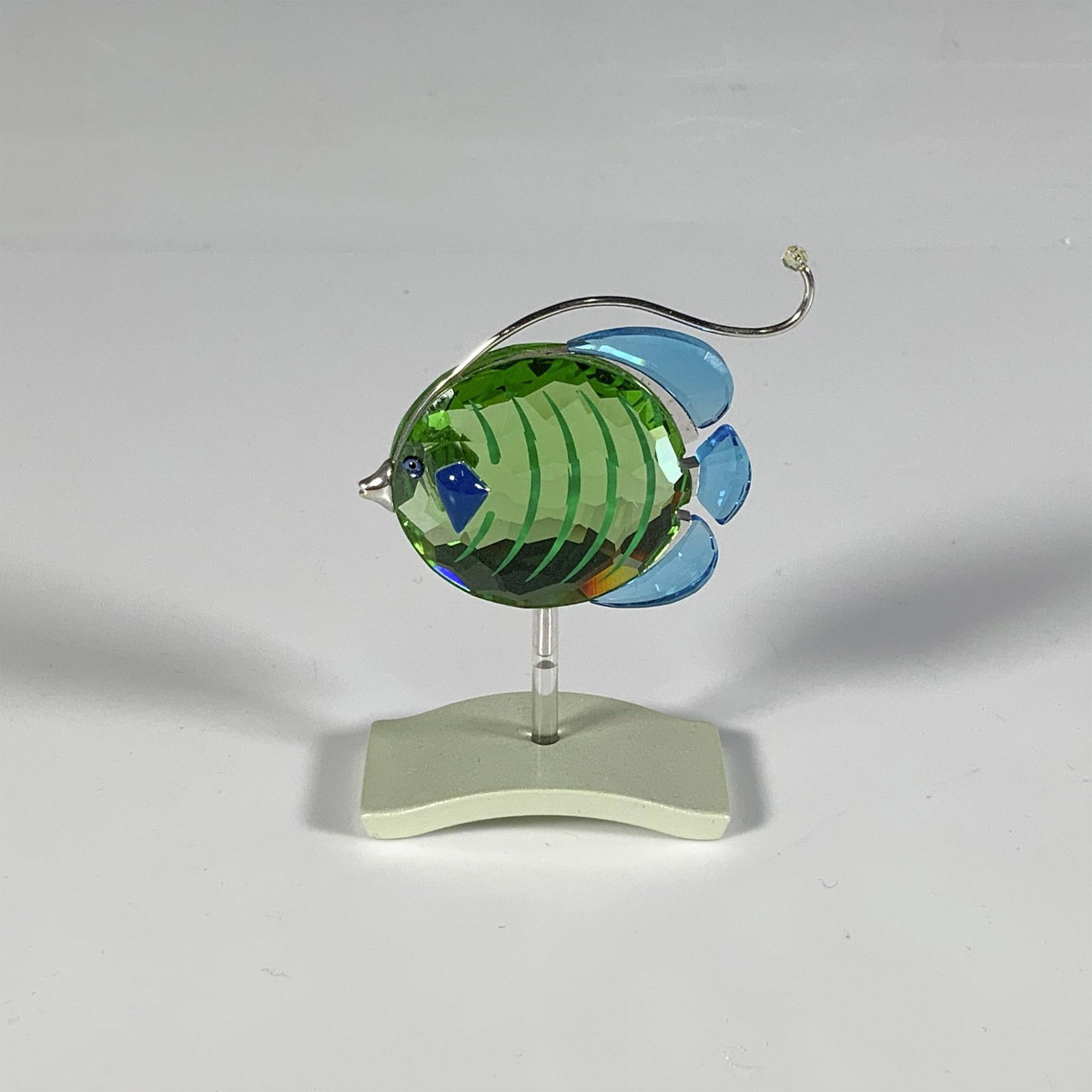 Swarovski Crystal Fish Figurine, Chira Peridot: Part of the Exotic Fish and South Sea collection, this delightful sea creature is crafted from blue and green crystal, enhanced with silver-toned accents. Swarovski marking. This item has a base inclu