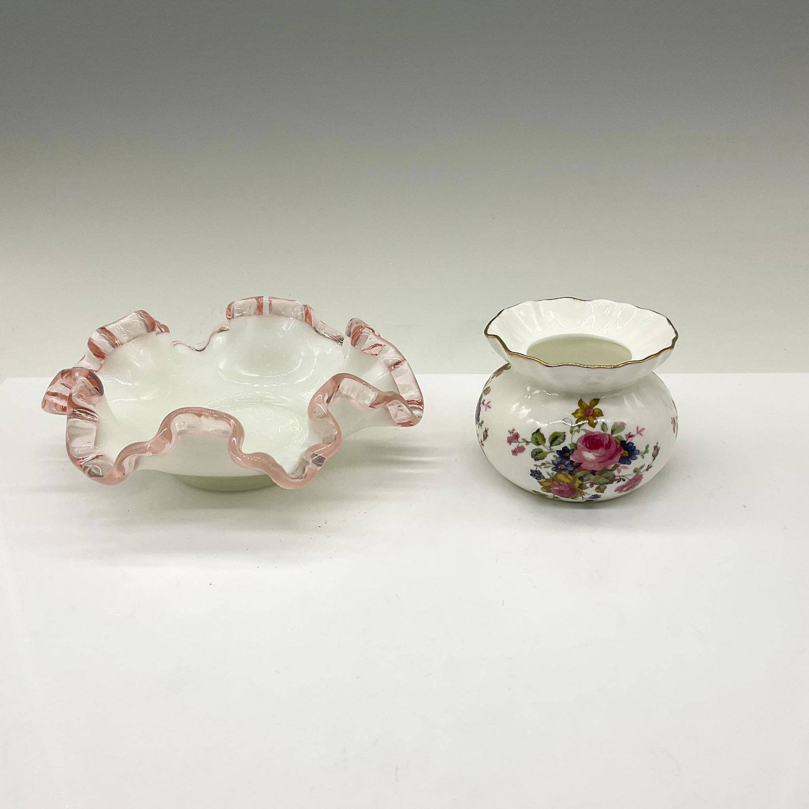 Vintage Fenton Candy Dish and Allyn Nelson Bone China: Fenton Rose Crest series with handkerchief design on rim in pink glass and white milk glass bottom measuring 2.5"H x 6"dia. The second piece is a miniature vase in bone china designed with bouquets of